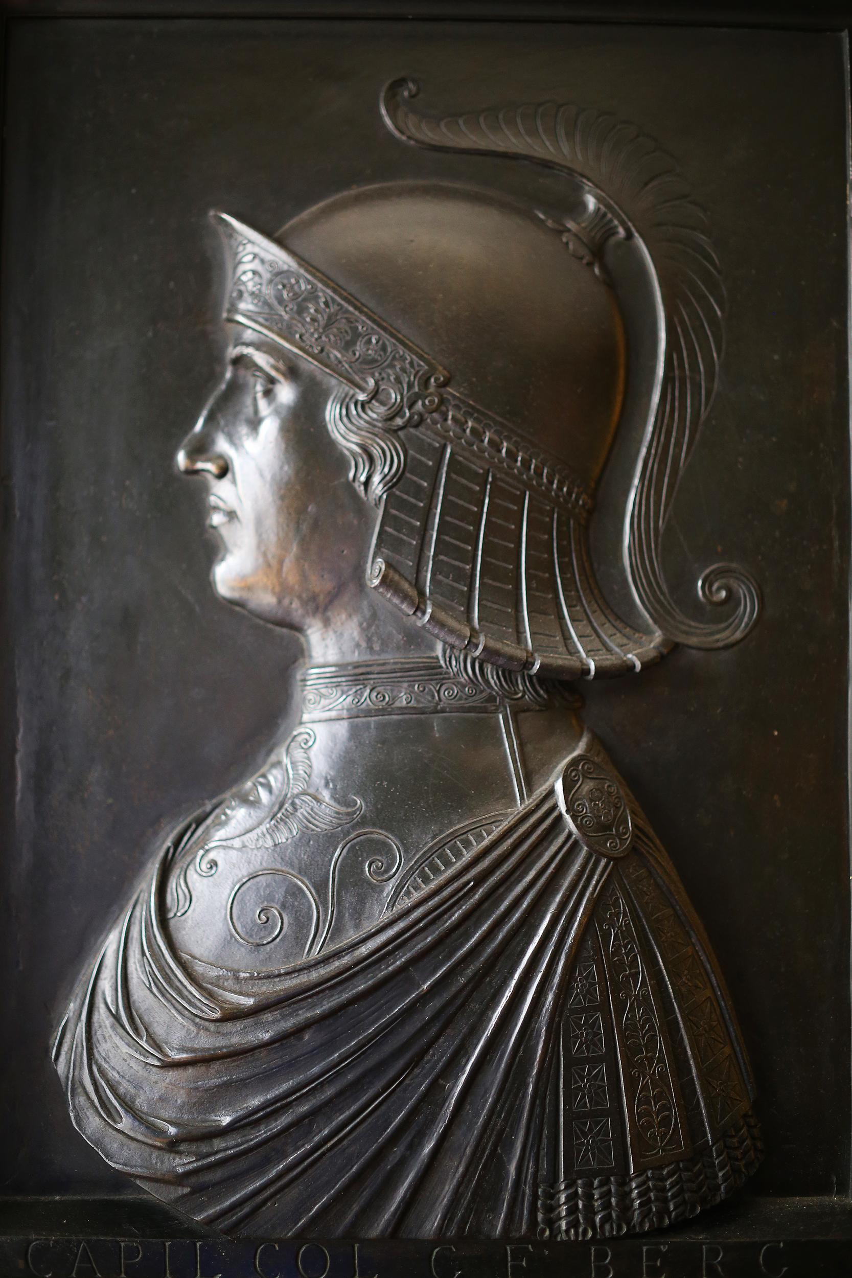 A spectacular bronze relief of sublime detail depicting the General Capiliata Colleoni in profile. The general is shown wearing a plumed helmet and cuirass with sculpted breastplate aegis. The inscription notes the friendship of the warrior with the
