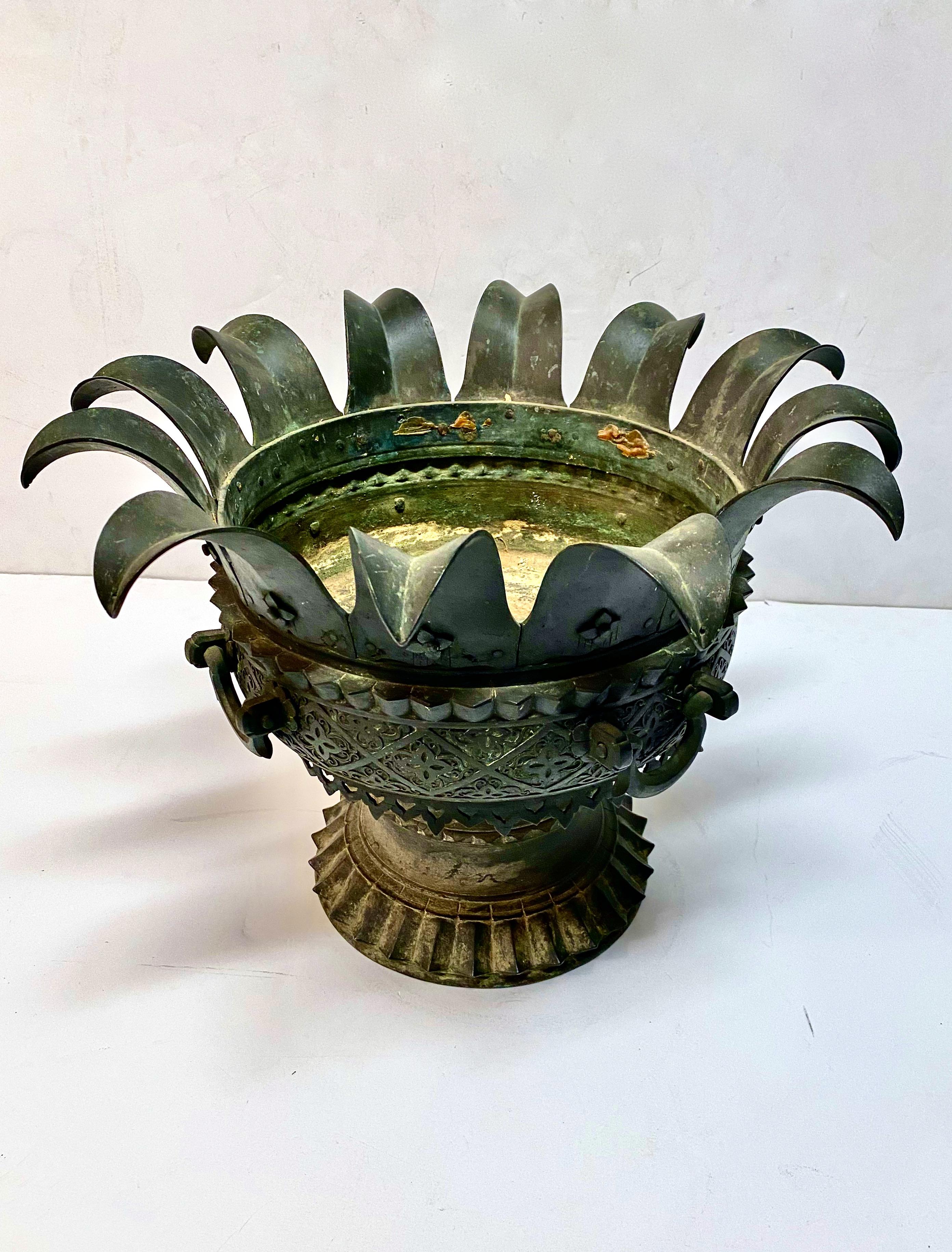 This is a highly detailed Renaissance Revival Middle Eastern inspired bronze planter. The palm fronds, unusual handles, heavy cast foot and Moorish-style fret work are indications of quality design and fabrication. This planter would make an