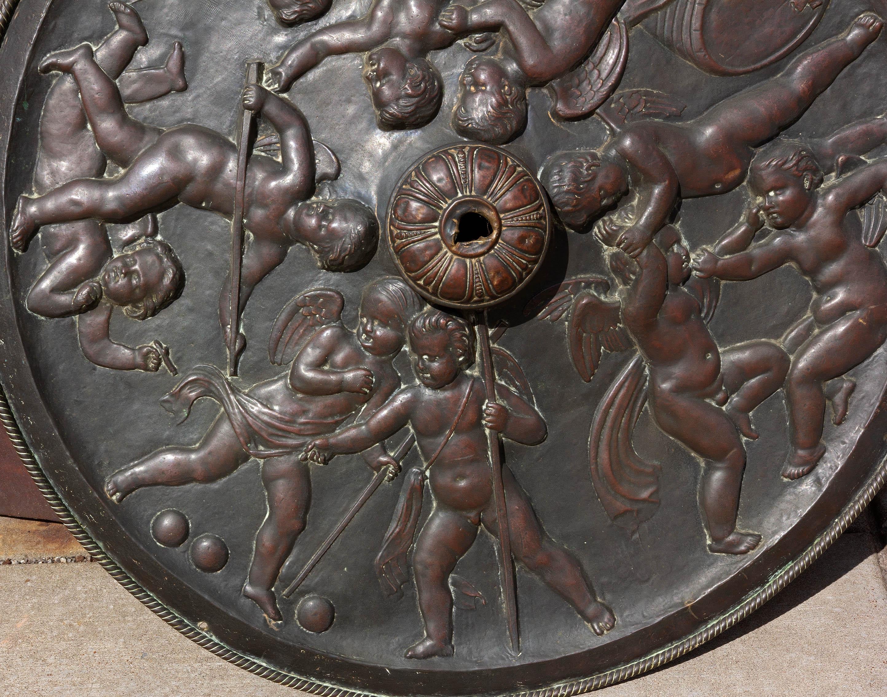 19th century bronze patinated repousse ceiling medallion. Three dimensional scene of reveling followers of Bacchus.