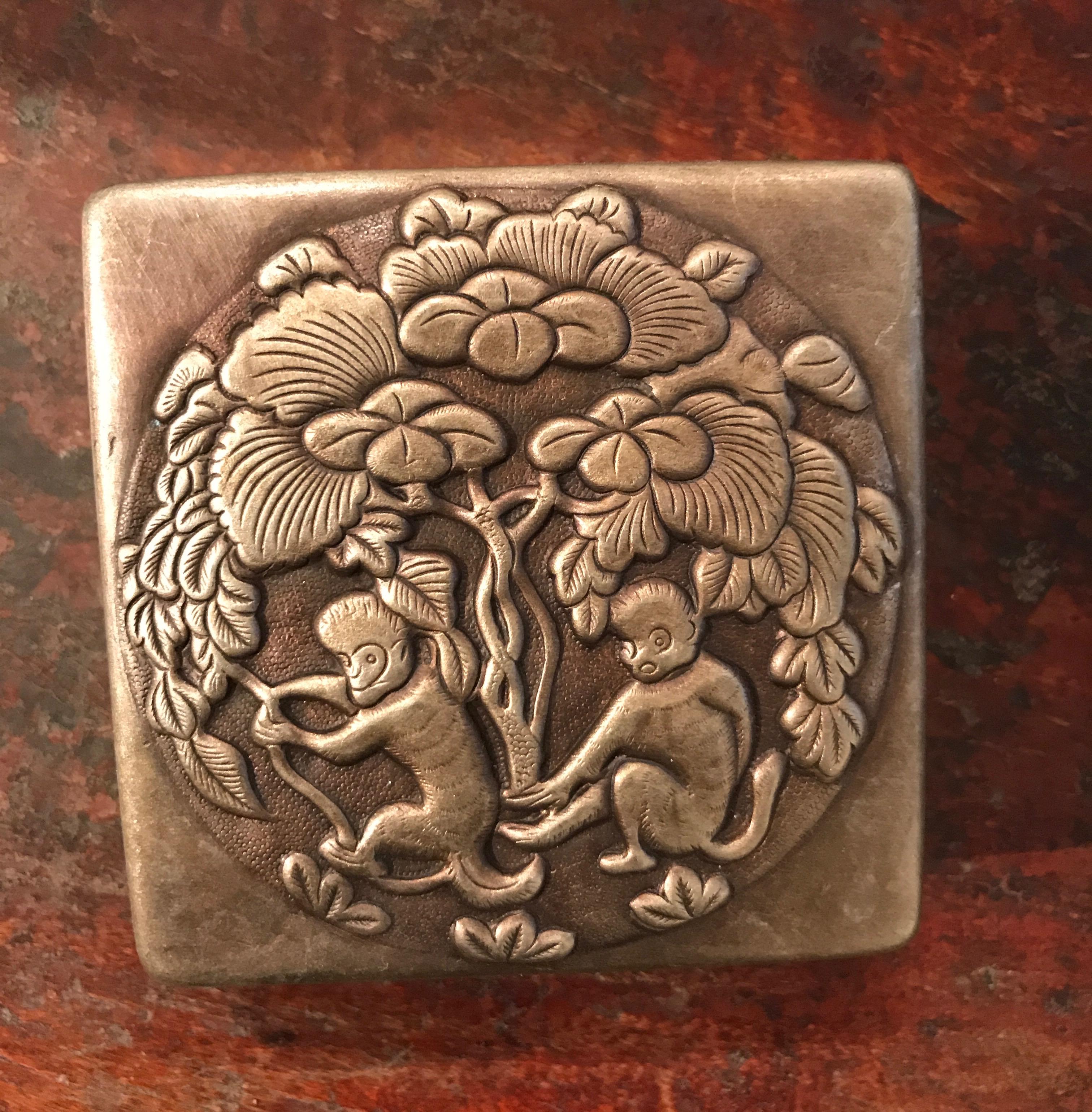 An old and nicely worn bronze Chinese ink box with carefully crafted whimsical images of two prancing monkeys. A great representation of turn of the Century China, showing it's years of use. This piece is practical as well as beautiful. It works
