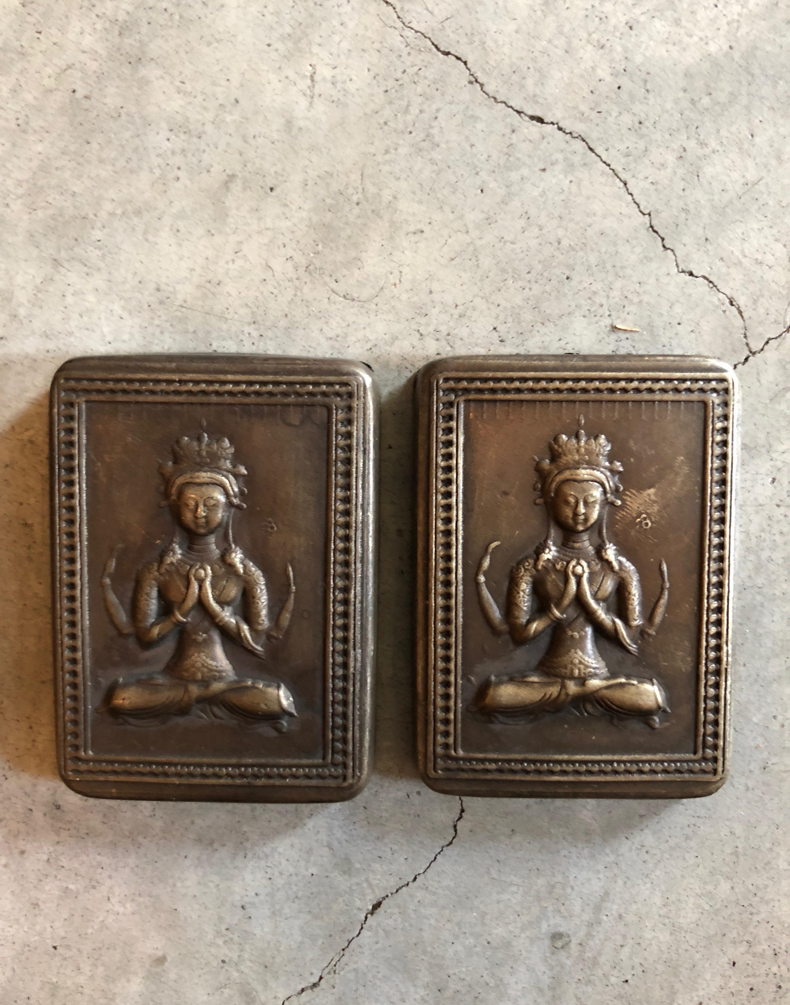 Small, perfectly worn bronze ink boxes with beautifully crafted repousse images of Buddha on the front and striking, elaborate engraving on the back of each box. These unusual and stunning objects work perfectly as small jewelry boxes (see images).