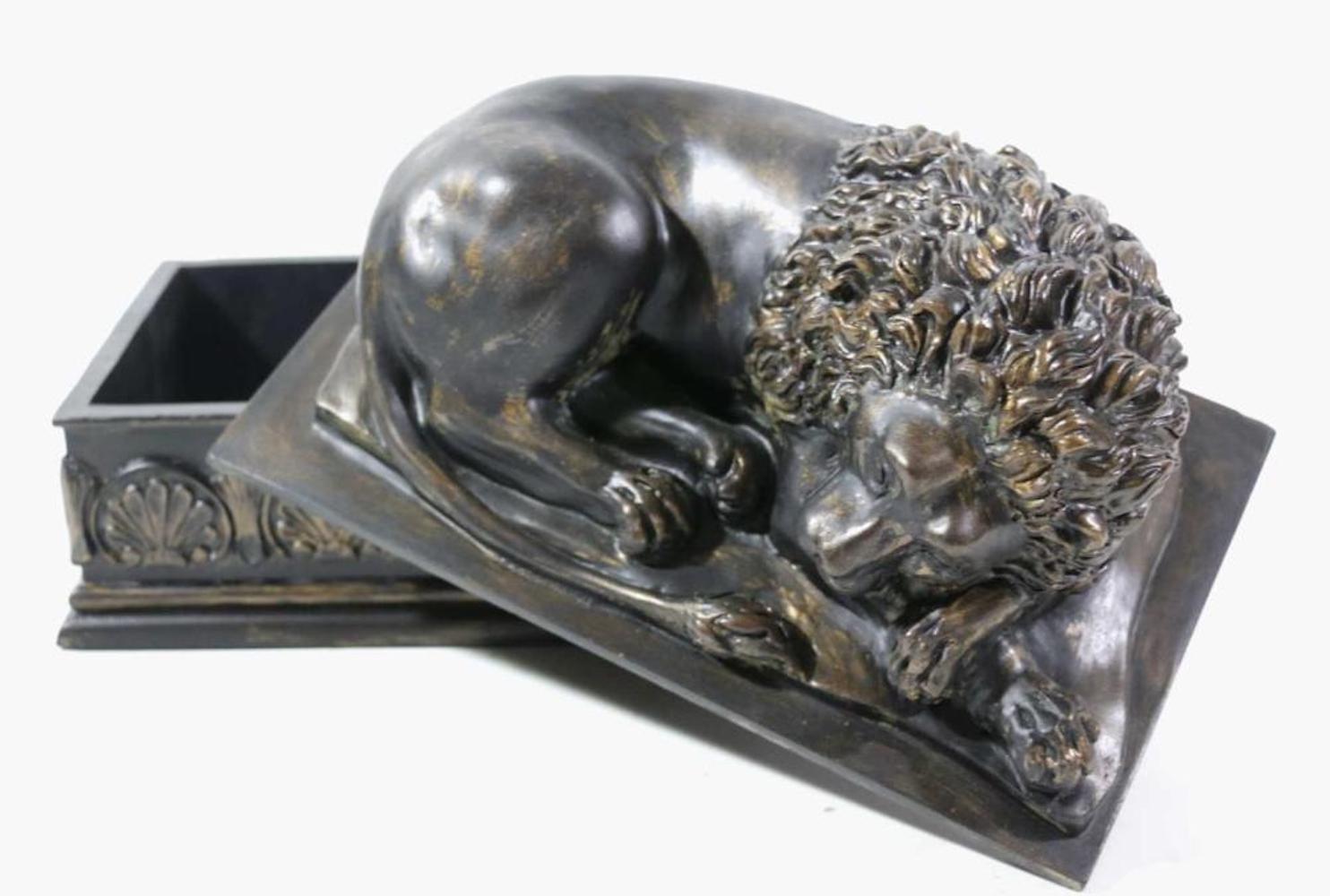 Bronze resting lion on plinth based box.