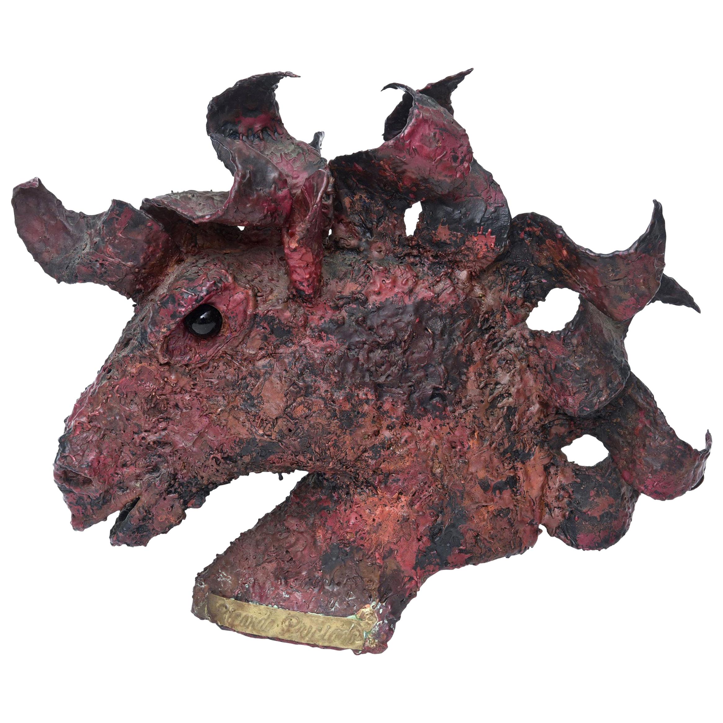 This heavy signed horse head sculpture has a metal plate that is signed by Ricardo Preciado. The use of dramatic paint over the bronze in a special acid like technique and the cut metal bronze mane make this a very dimensional bust. It looks like a