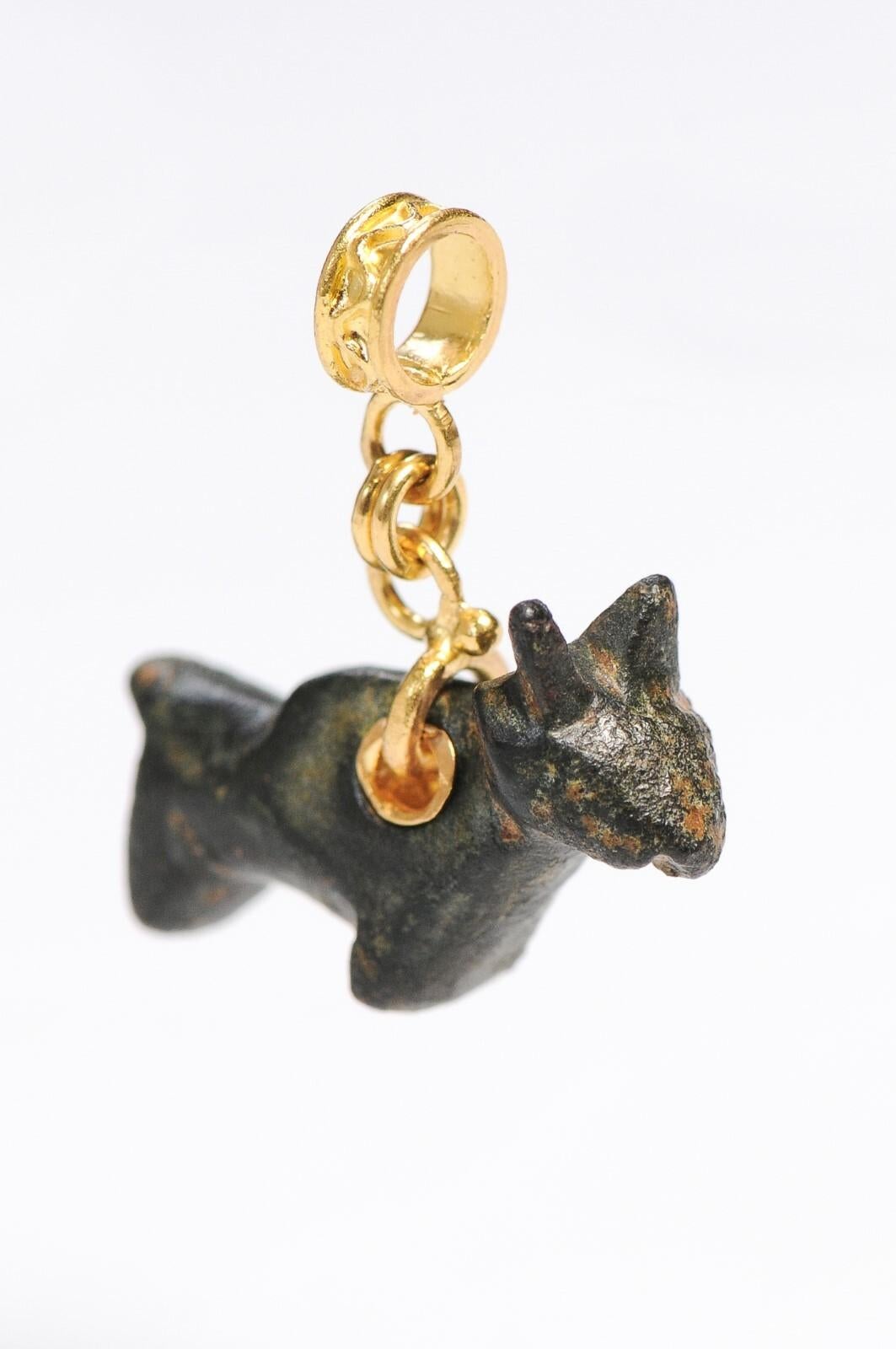 A bronze Roman bull made into a pendant trimmed with 21K gold. This ancient bronze figurine was turned into a pendant by an artisan jeweler - it is unique and one of kind!  Measurements: 13/16