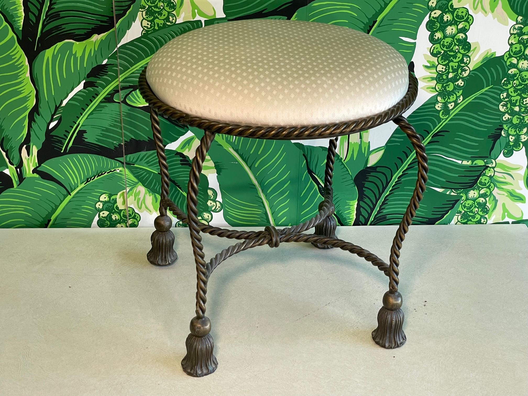 Heavy bronze vanity stool features a twisted rope motif and tassel feet. Good condition with minor imperfections consistent with age, see photos for condition details. 
For a shipping quote to your exact zip code, please message us.