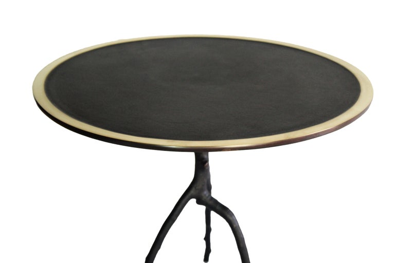 This handcrafted low table is made in France. With a apple tree branch as leg and a round tray with a polished contour, this side table is patined in black. Each side table is signed and numbered. This side table belongs to the Bronze Sauvage