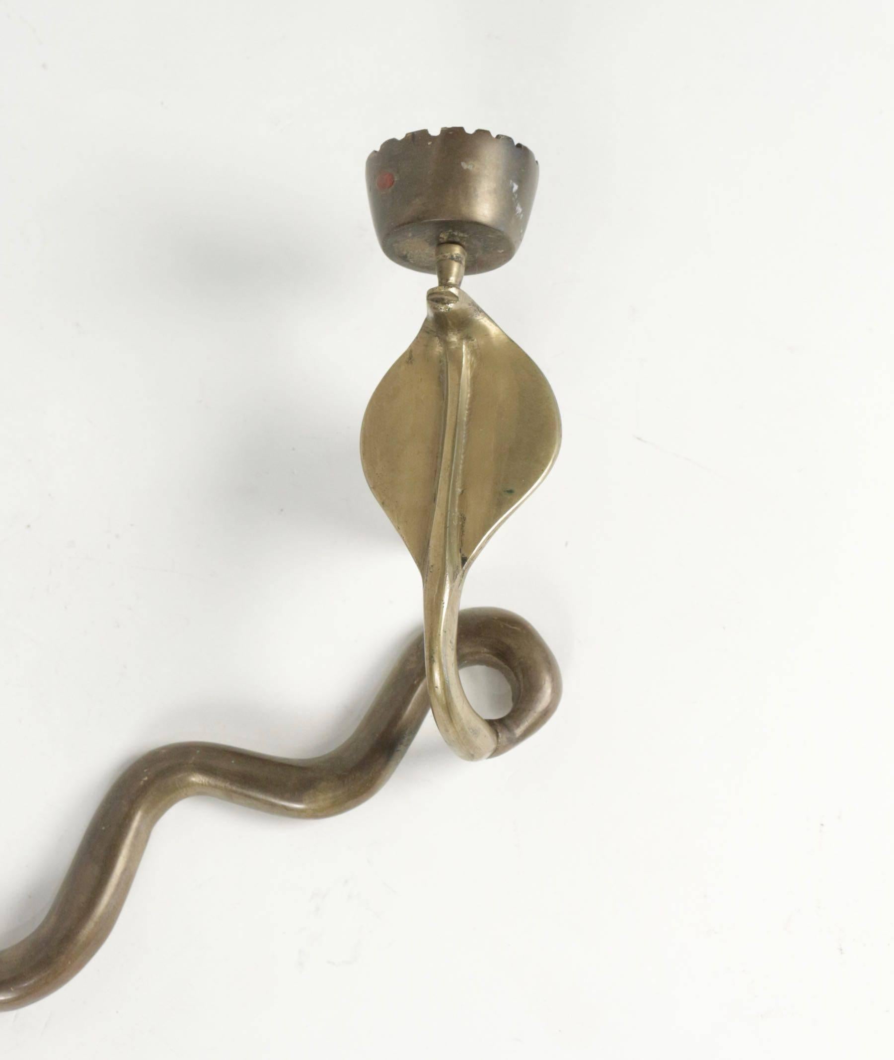 A bronze sconce of a cobra, circa 1960, midcentury design.
 