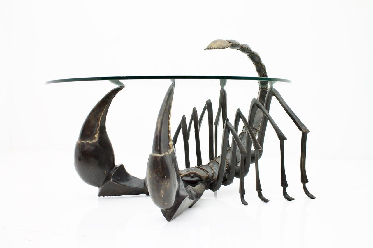 Jacques Duval-Brasseur attributed scorpion coffee table, France, 1970s.
Patinated bronze with a round glass top.

Good original condition.

Jacques Duval-Brasseur
Jacques Duval-Brasseurs preferred metal is brass, which he shaped, welded and polished