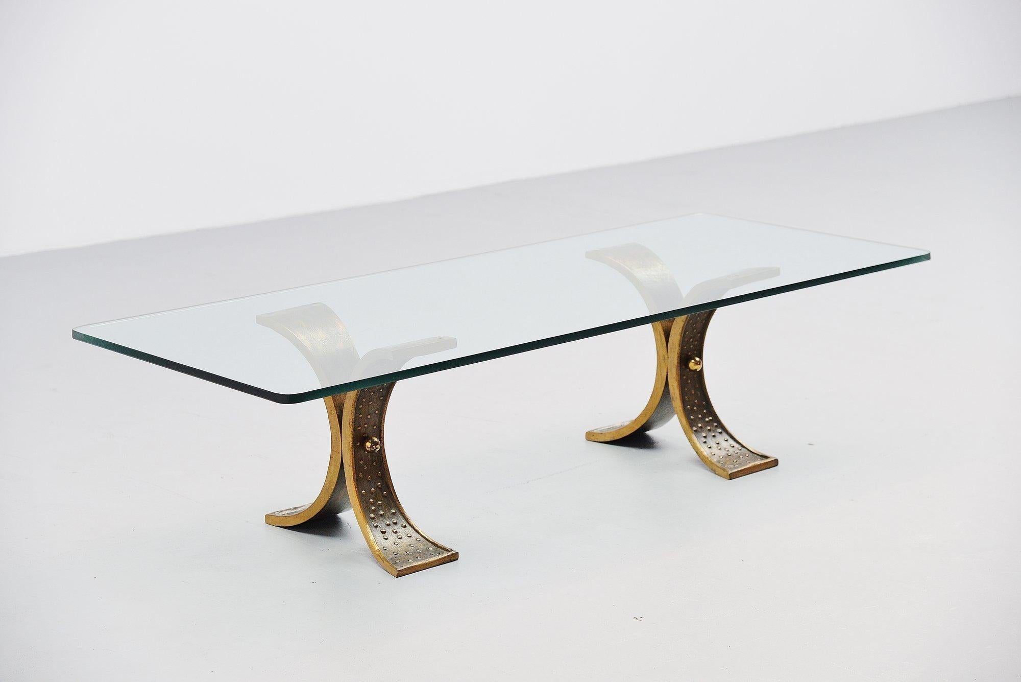 Nice large sculptural coffee table made in France 1970. This table has heavy solid bronze sculptural feet that support a thick glass rectangular top. The table is made by unknown designer or manufacturer but this shows quality all over. I think the