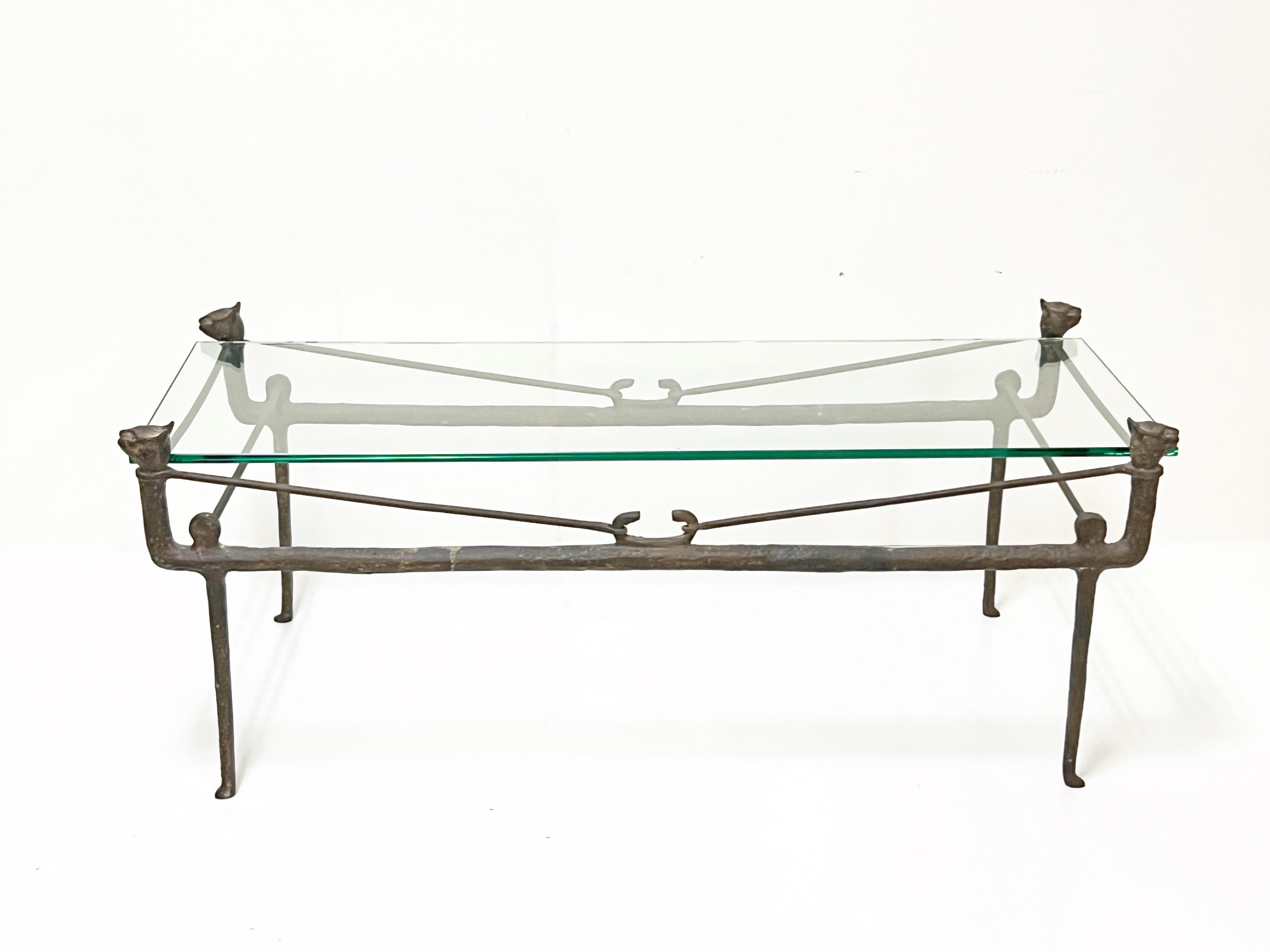 A bronze and glass coffee table in the style of Diego Giacometti. 