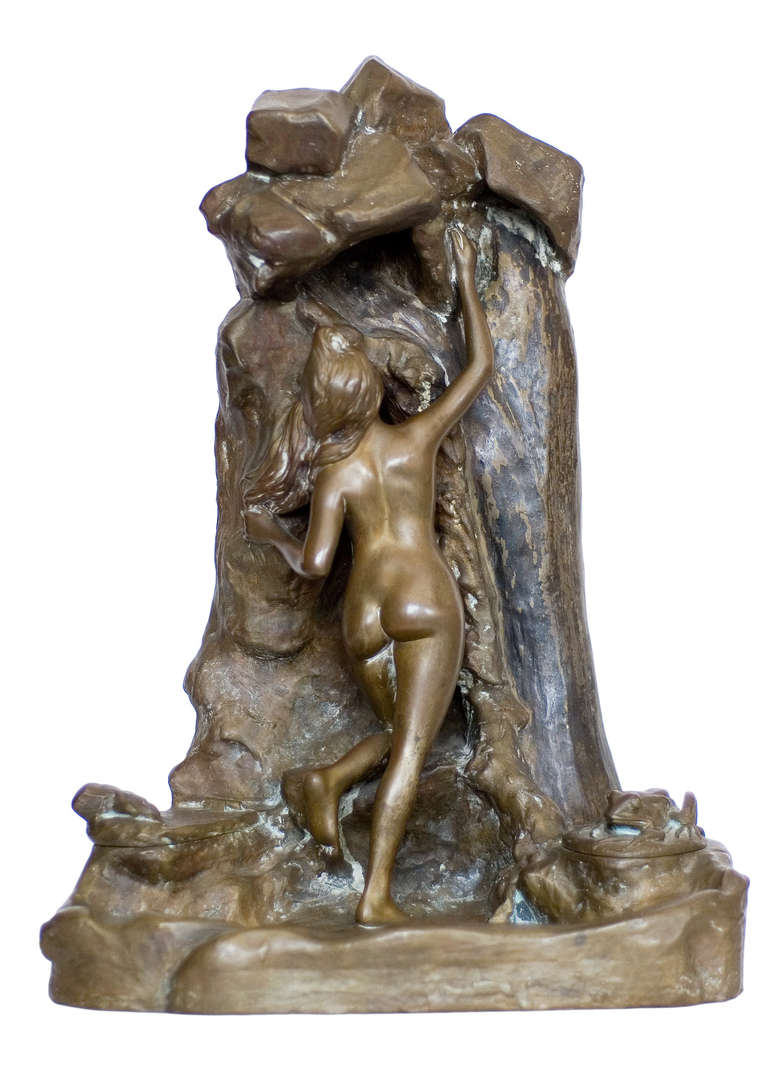 A lovely bronze sculpture featuring figural nude bathing in a natural spring in the style of French artists Jean Garnier. The trickle and eventual pooling of water are highlighted with a beautiful natural patina. The piece features a light above the
