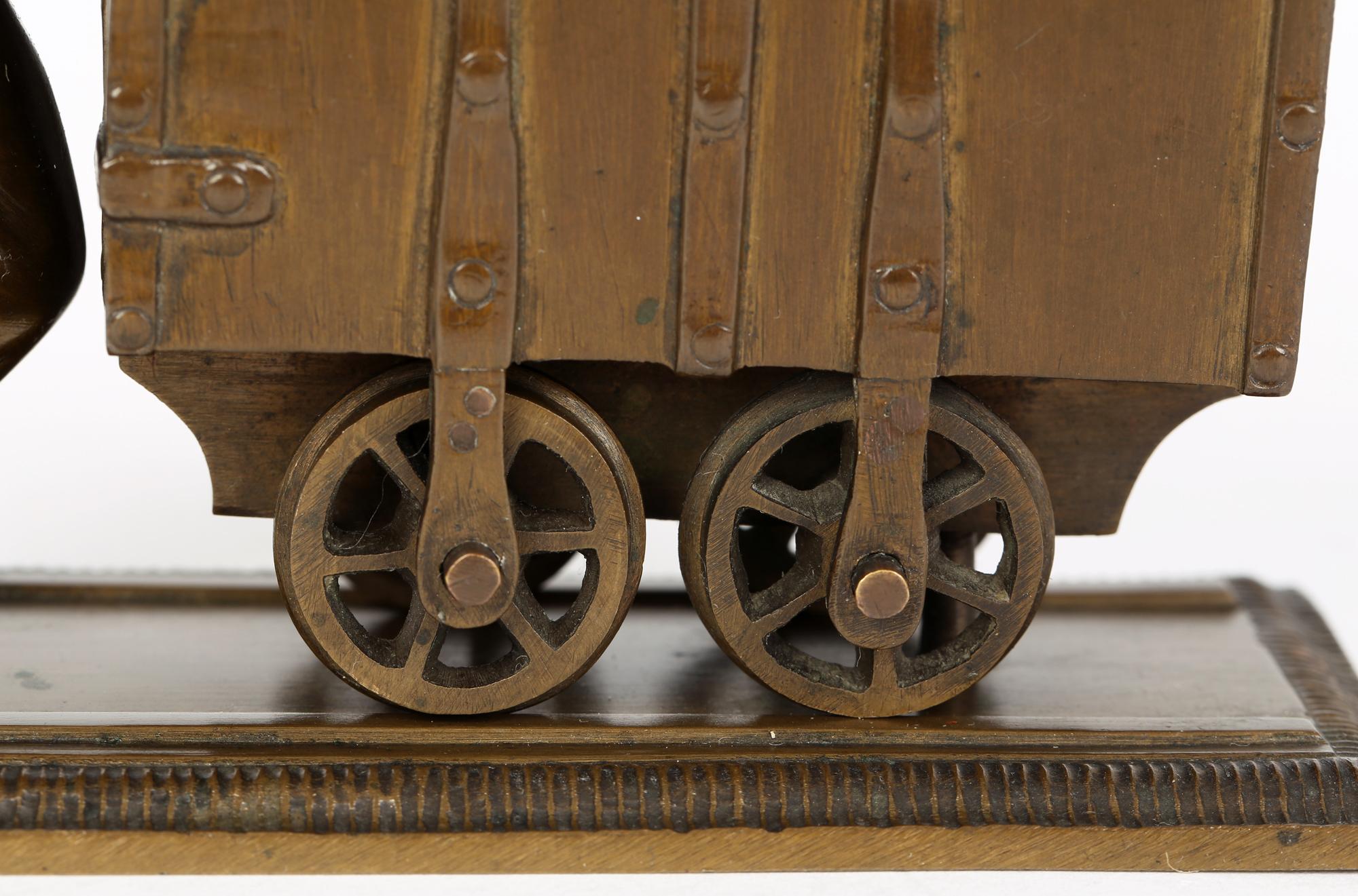 A charming and fine quality continental bronze sculpture of a collier with a coal trolley, probably Austrian and dating from around 1900. The sculpture is mounted on a rectangular base with two rail tracks to either side and with a man in period