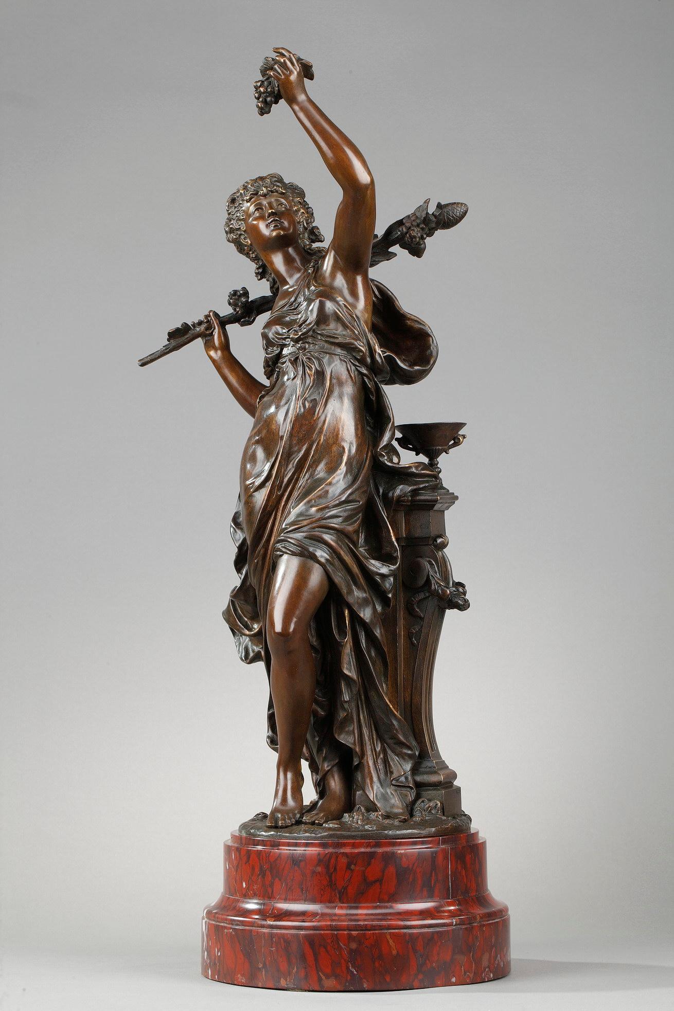 Bronze sculpture with brown patina, the Allegory of the Vine signed Hippolyte Moreau (1832-1927)represents a draped woman with braided hair held back, holding in her raised hand a bunch of grapes and in the other a thyrse placed on her shoulder. The