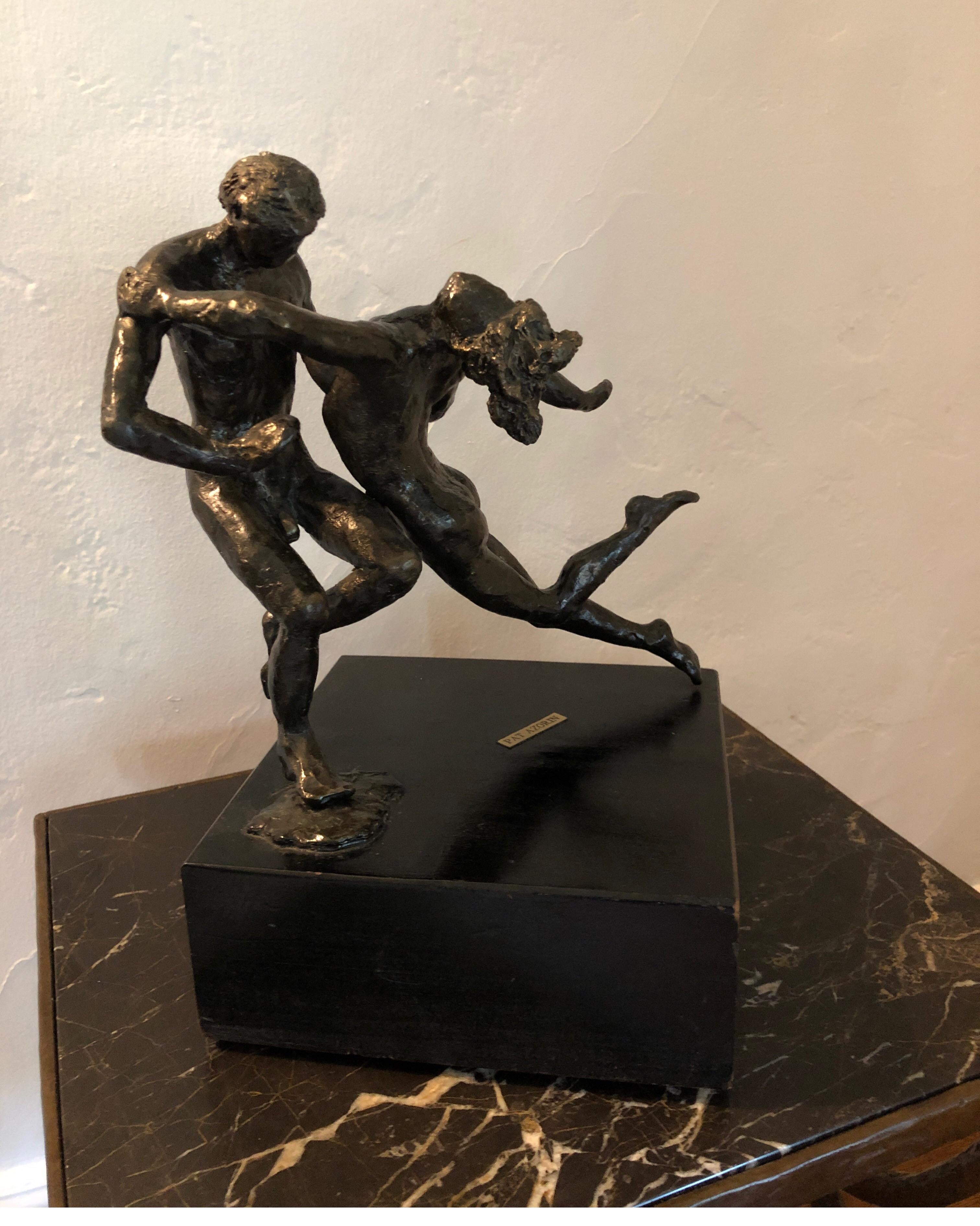 Bronze statue of nudist man and woman ballet dancing. Woman’s legs extended with her head back in spinning motion.
Cannot find any signature on the statue, but has Edgar Degas style.
Mounted on a wood base with built in turning swivel. Has the