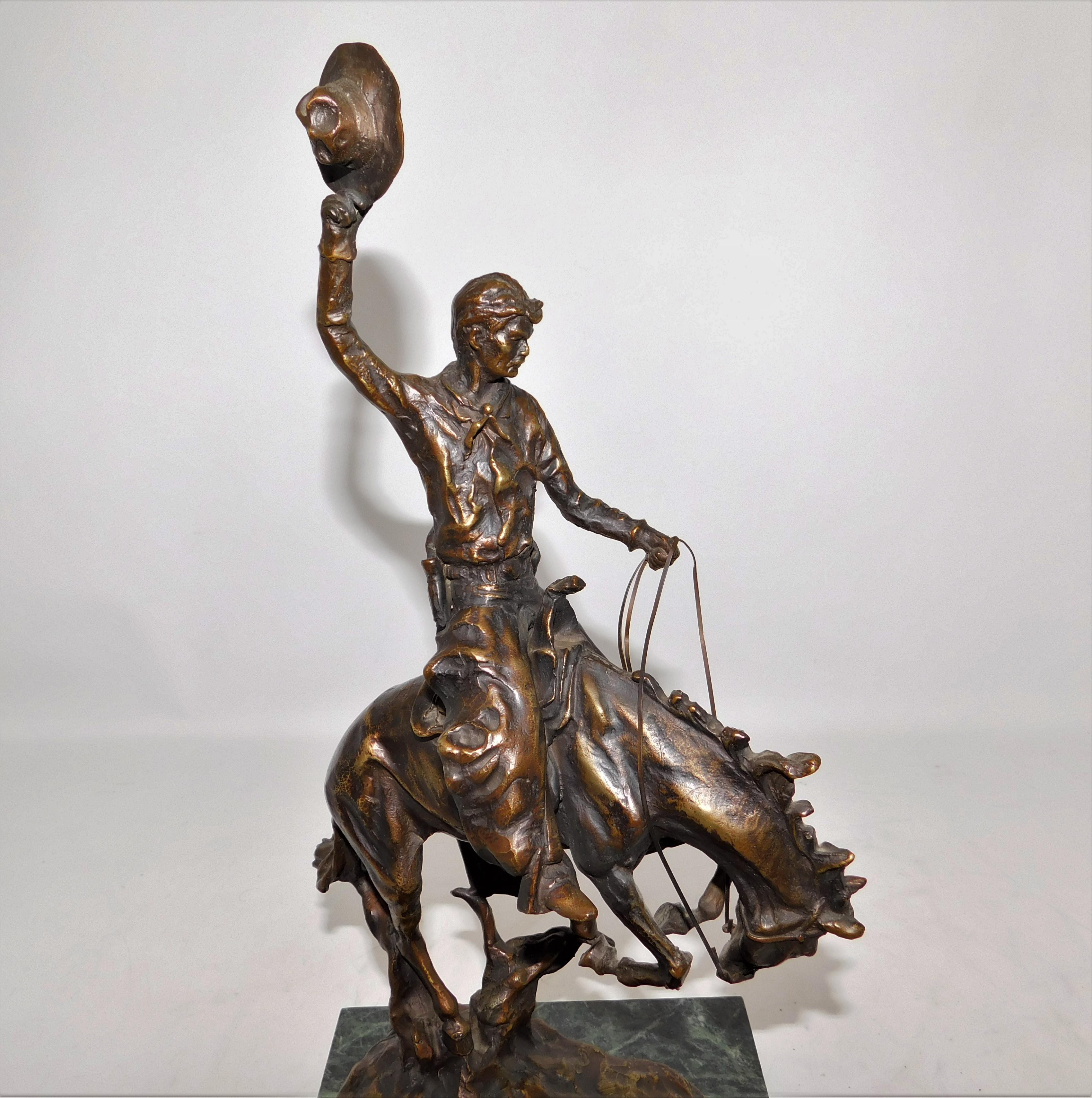 Early 20th century bronze on Marble slab sculpture of a bronco rodeo cowboy on horse by Austrian artist Carl Kauba. Weighing a heavy 18 pounds with a solid marble base, Kauba has amazing intricate detail from the reins to the cowboys face and horses