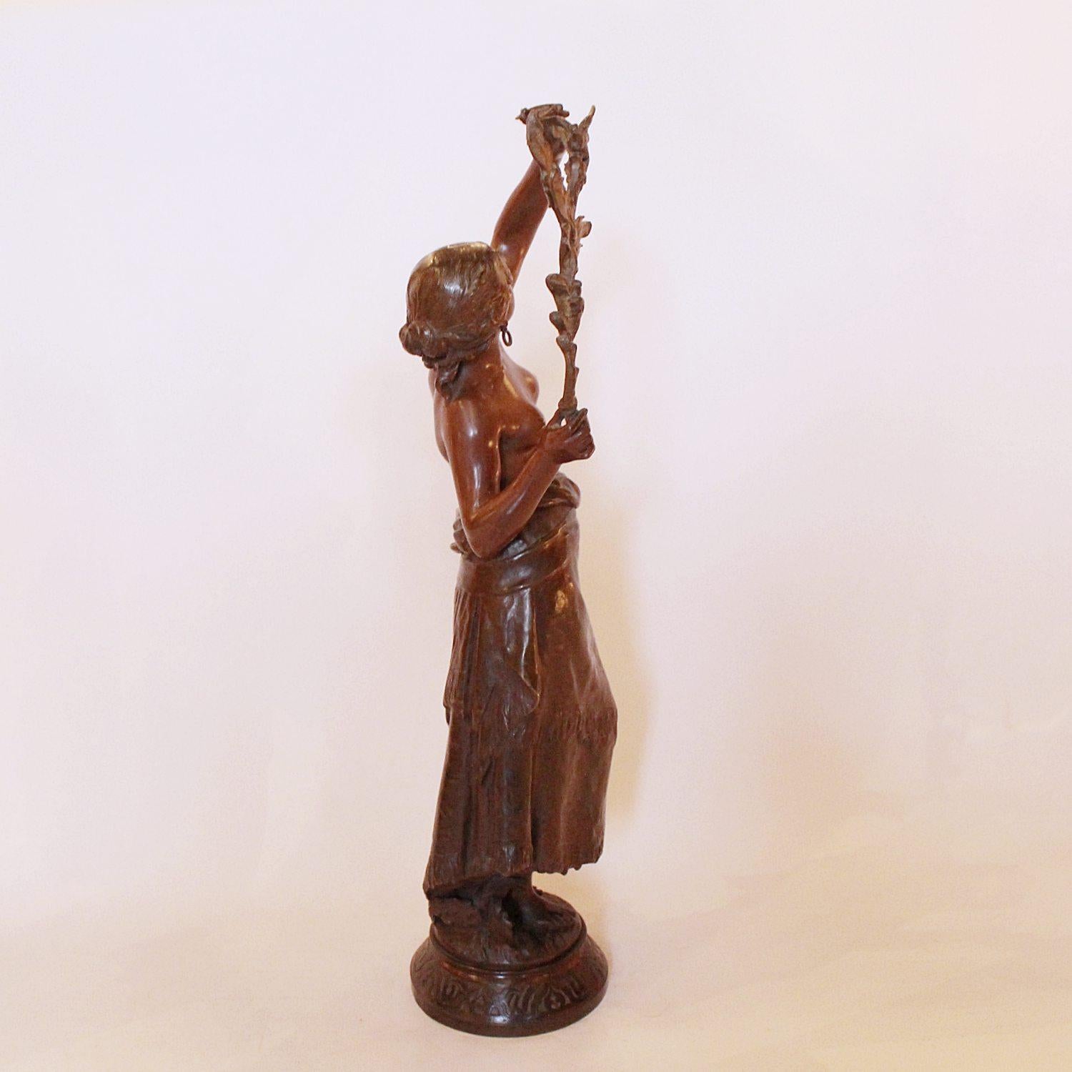 A late 19th century bronze sculpture of a scantily clad young lady, holding aloft a branch with birds perching on it. Set over a raised, decorated bonze plinth. Signed Auguste Moreau to cast.

Artist: Auguste Moreau (1834-1917)

Dimensions: H 50
