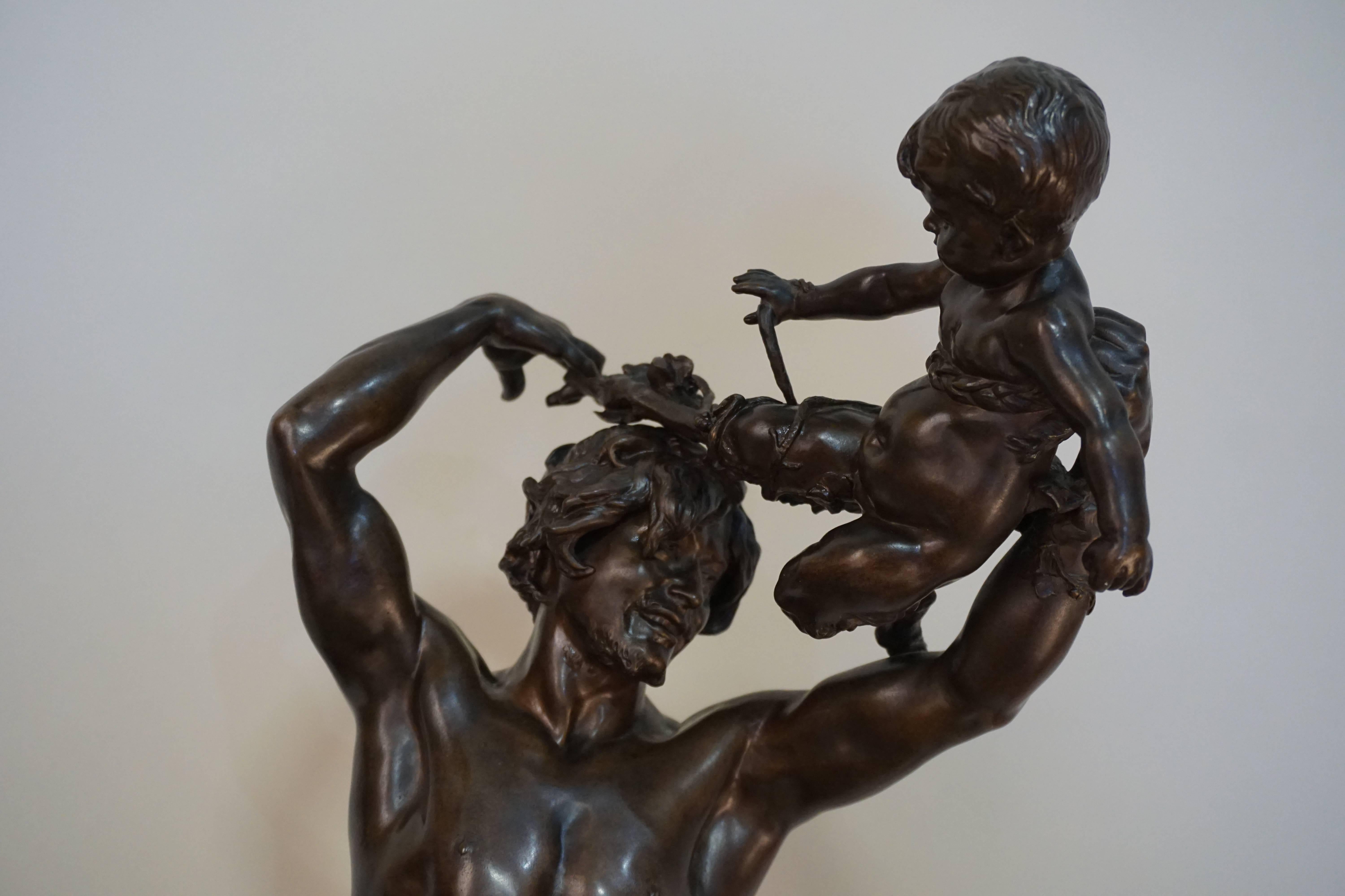 Bronze sculpture by the French sculptor Léopold Clément Steiner depicts the wine god Bacchus, who holds up a Satyr/Faun- Greek myth.