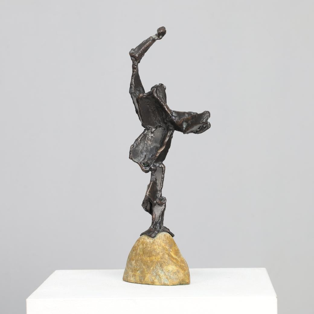 An expressive bronze sculpture by Dutch artist Hugo Hol, created in the 1970s. The figure rises dynamically from a natural stone base, its angular form and welded texture evoking both strength and motion. The piece captures a sense of upward