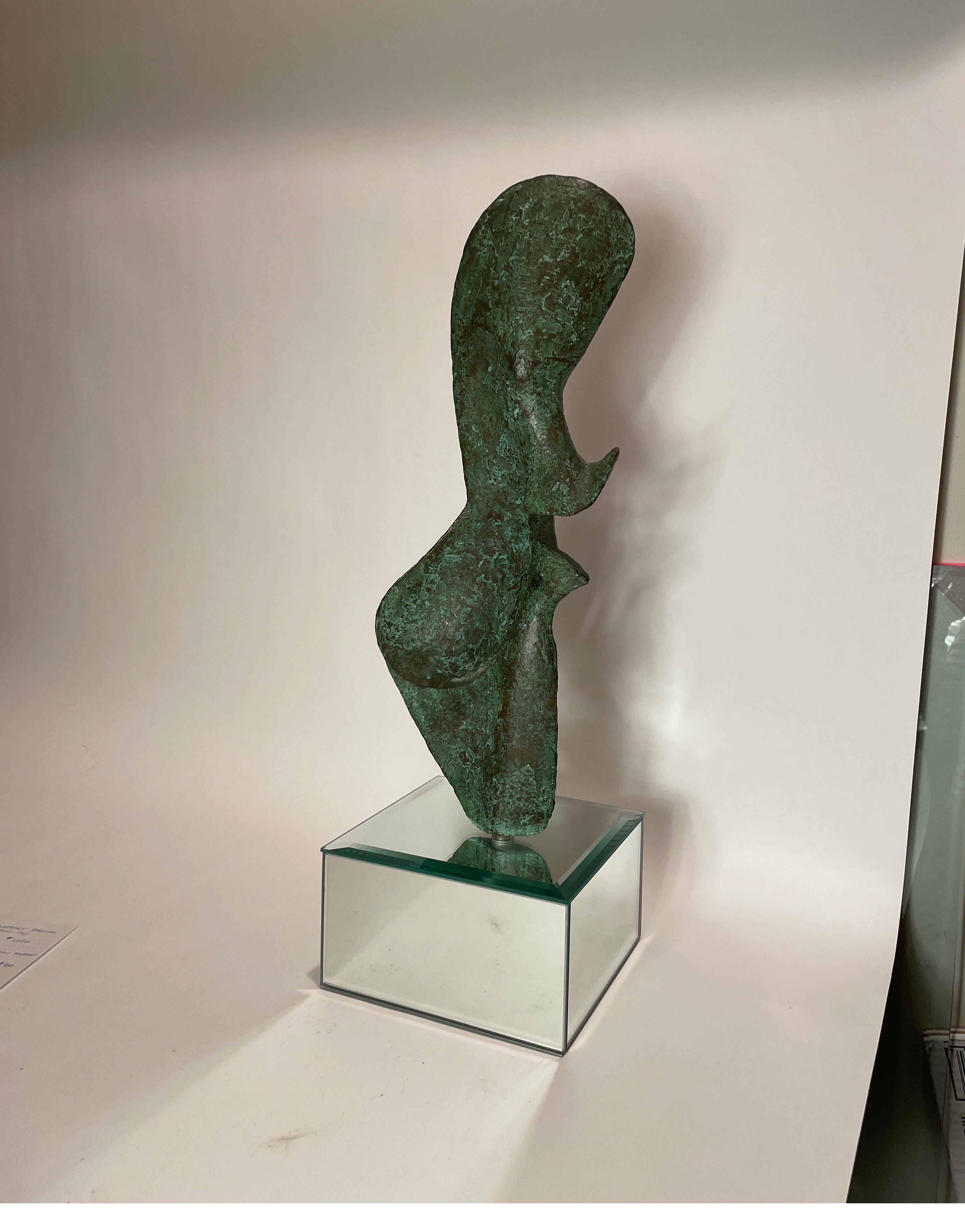 Signed bronze sculpture by Leonardo Nierman on a mirror base.
dimensions include base.