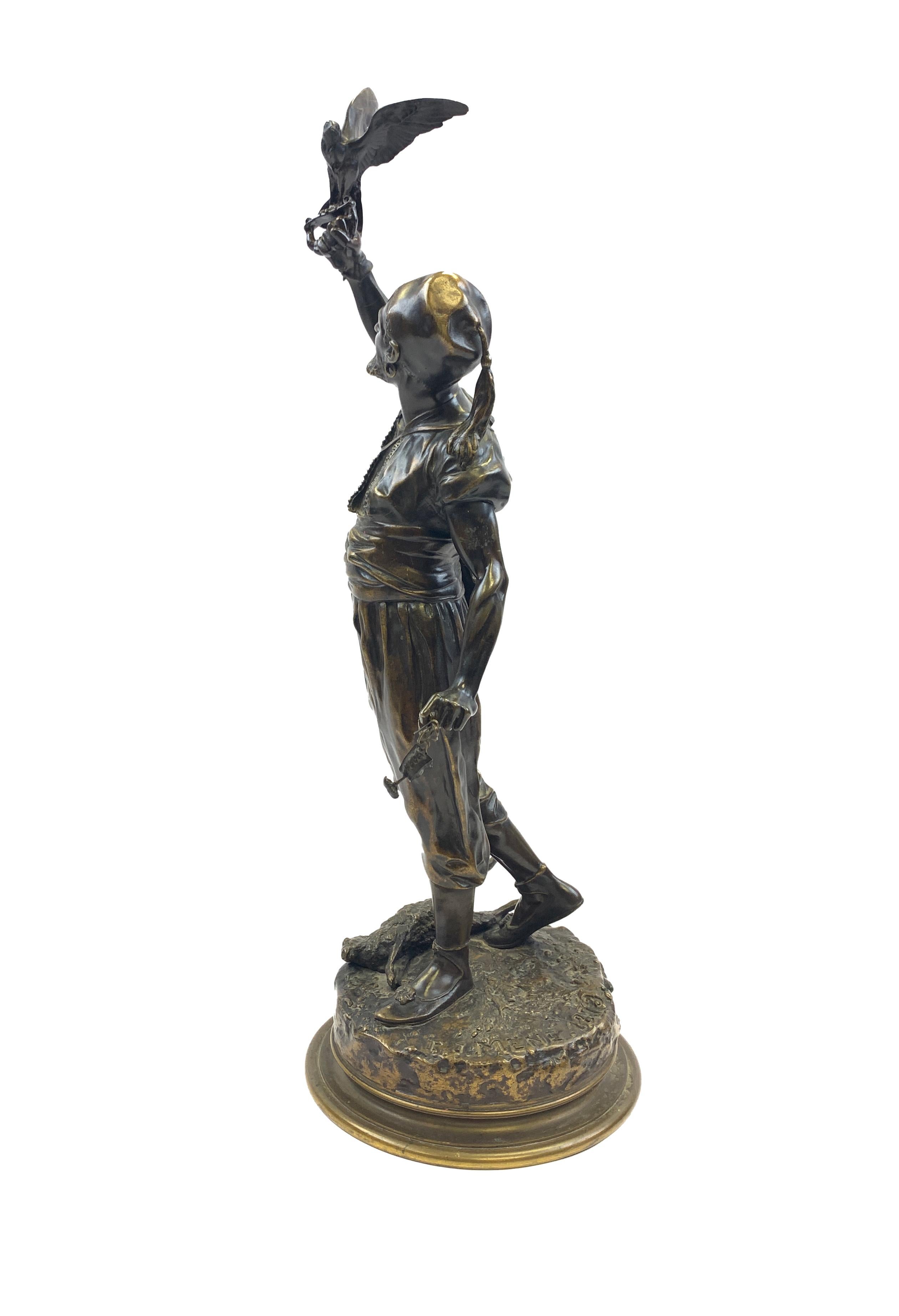 Sculpture en bronze à patine brune, représentant un homme et son faucon, signée P.J Mene & datée 1873 sur la base ronde.