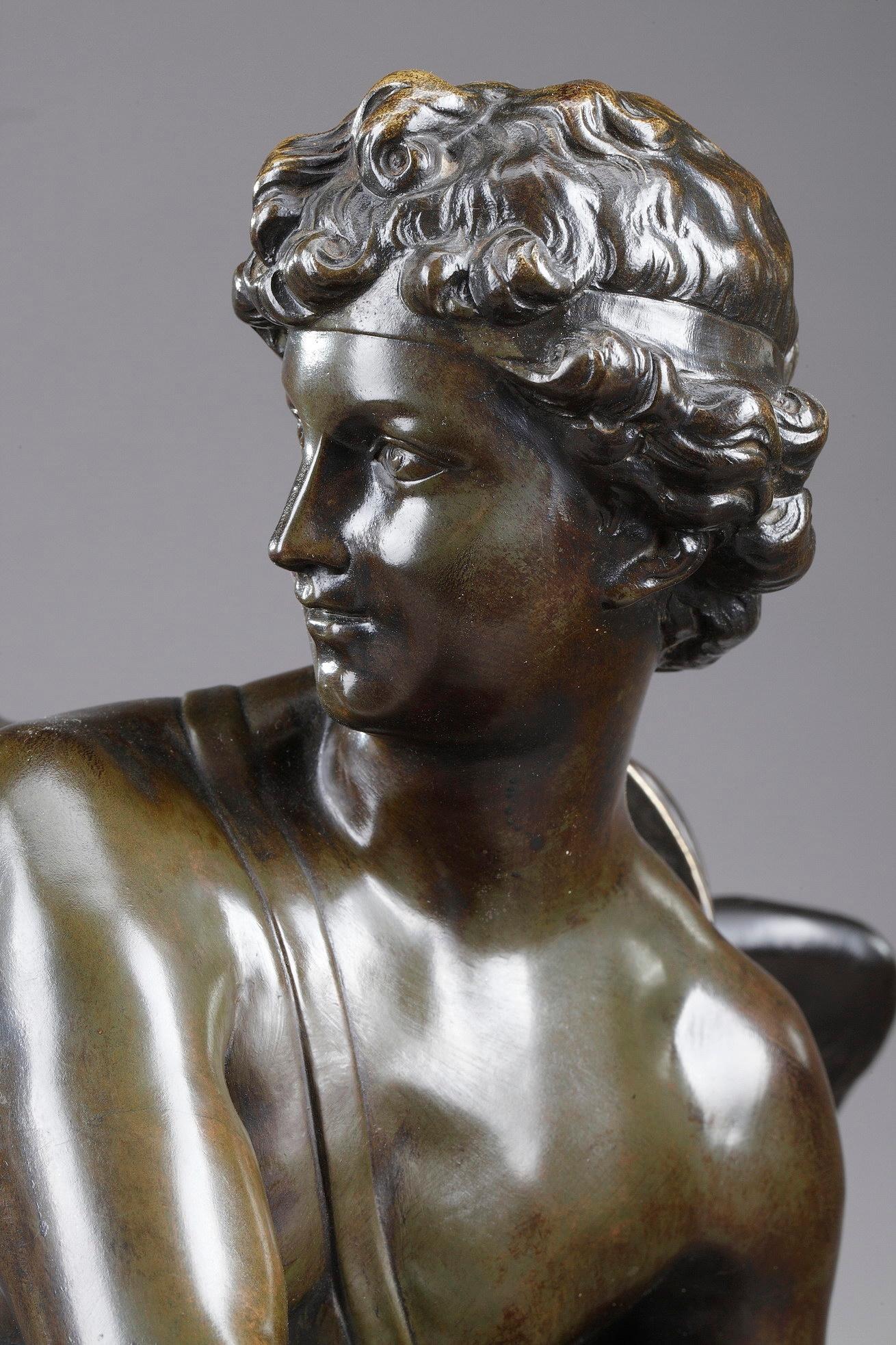 Large patinated bronze sculpture featuring Cupid or Eros, God of love, attraction and affection in classical mythology, preparing to shoot his arrow. He is portrayed as a slender winged boy, wearing a bow and a quiver filled with arrows. The bow and