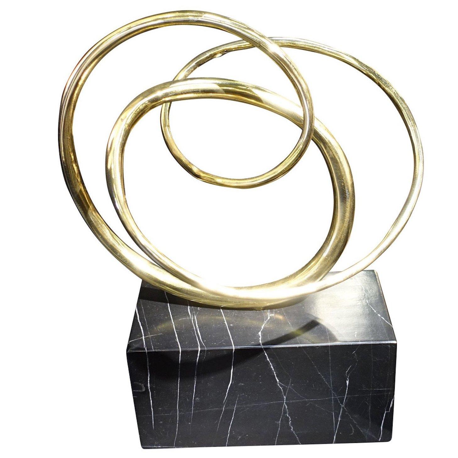 Contemporary German three bronze interlocking rings on black marble stand sculpture.
Moves to show different positions.
Stand measures 8 inches x 4 inches.

 