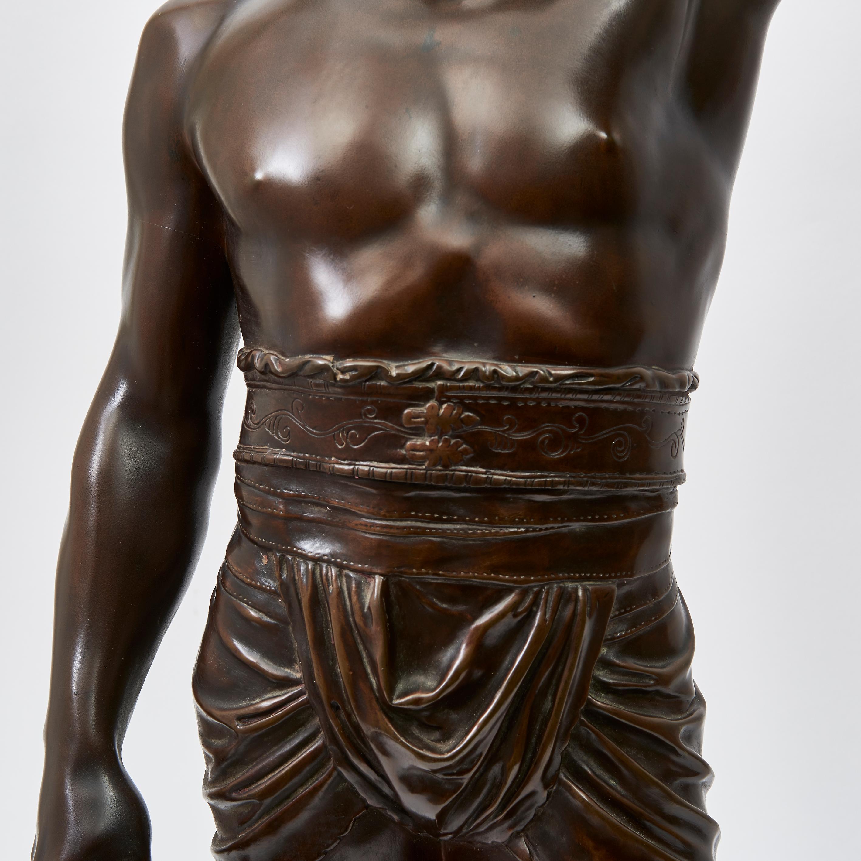 Bronze sculpture of a Gladiator, signed on the reverse by the French Sculptor Emile Guillemin (1841-1907). The Roman gladiator proudly brandishing his shield in the air, spear in other hand, with classical muscular form. The sculpture inscribed at