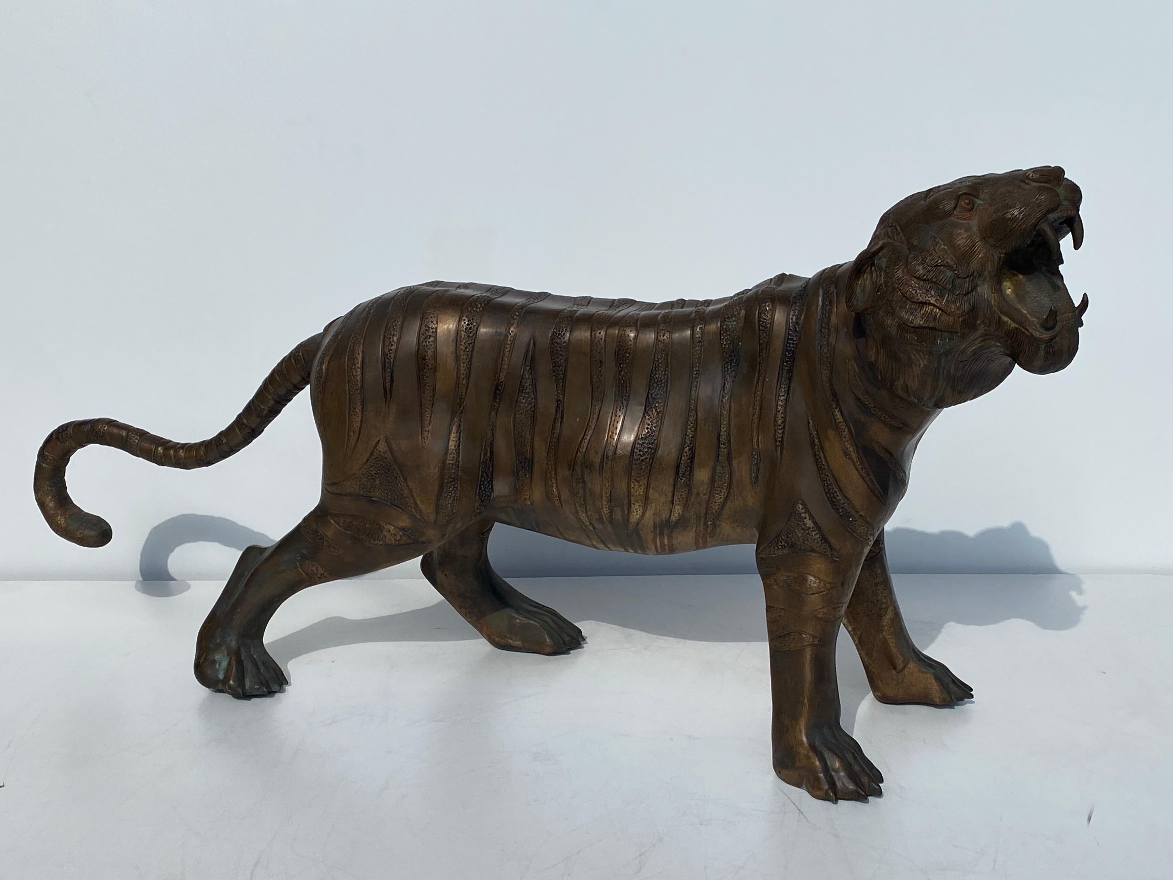 Indoor- outdoor patinated bronze sculpture of a roaring Bengal Tiger.
