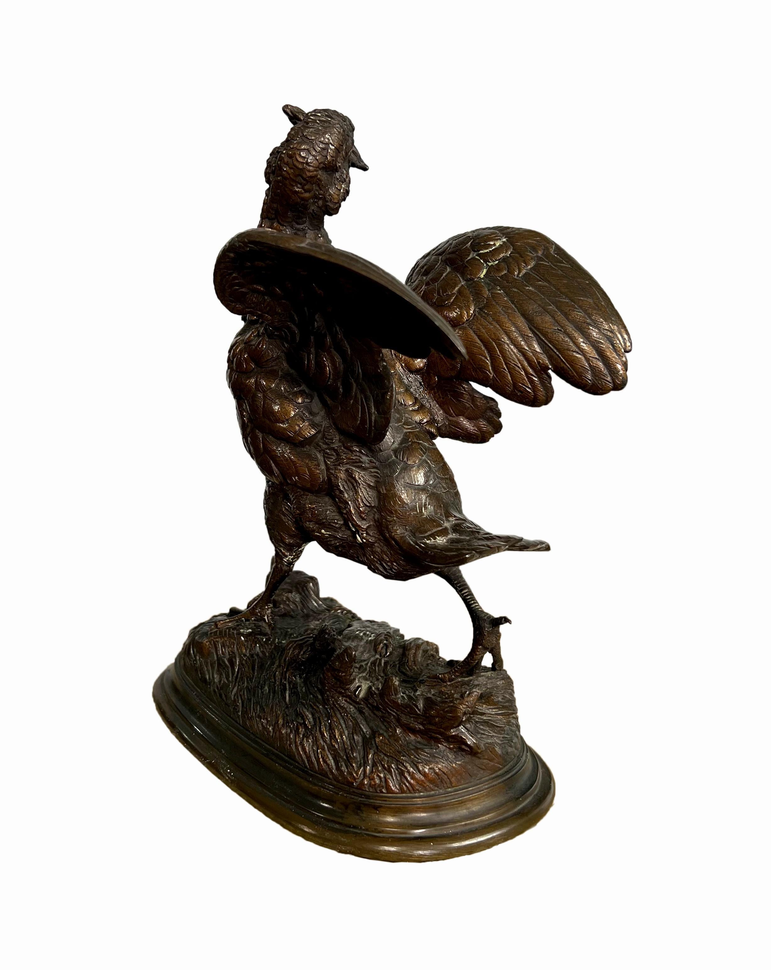 A French patinated bronze sculpture of a grouse with wings spread, carrying a sheaf of wheat in its beak, raised on oval base, after a model by Alfred Barye (1839-1882)
Incised: BARYE.

Height