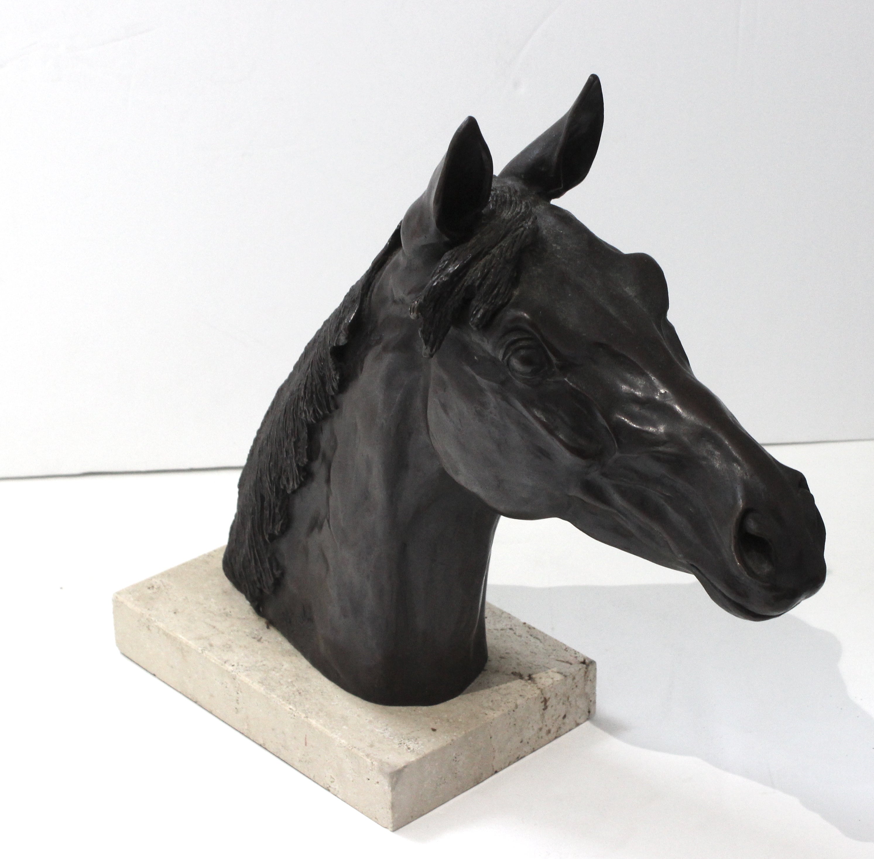 This stylish bust of a horse was created by the American sculptor Nancy Weimer Belden, and it dates to 1974.

Note: Signed and dated on the left lower neck of the head.

Note: There looks to be an old restoration to the travertine base on the