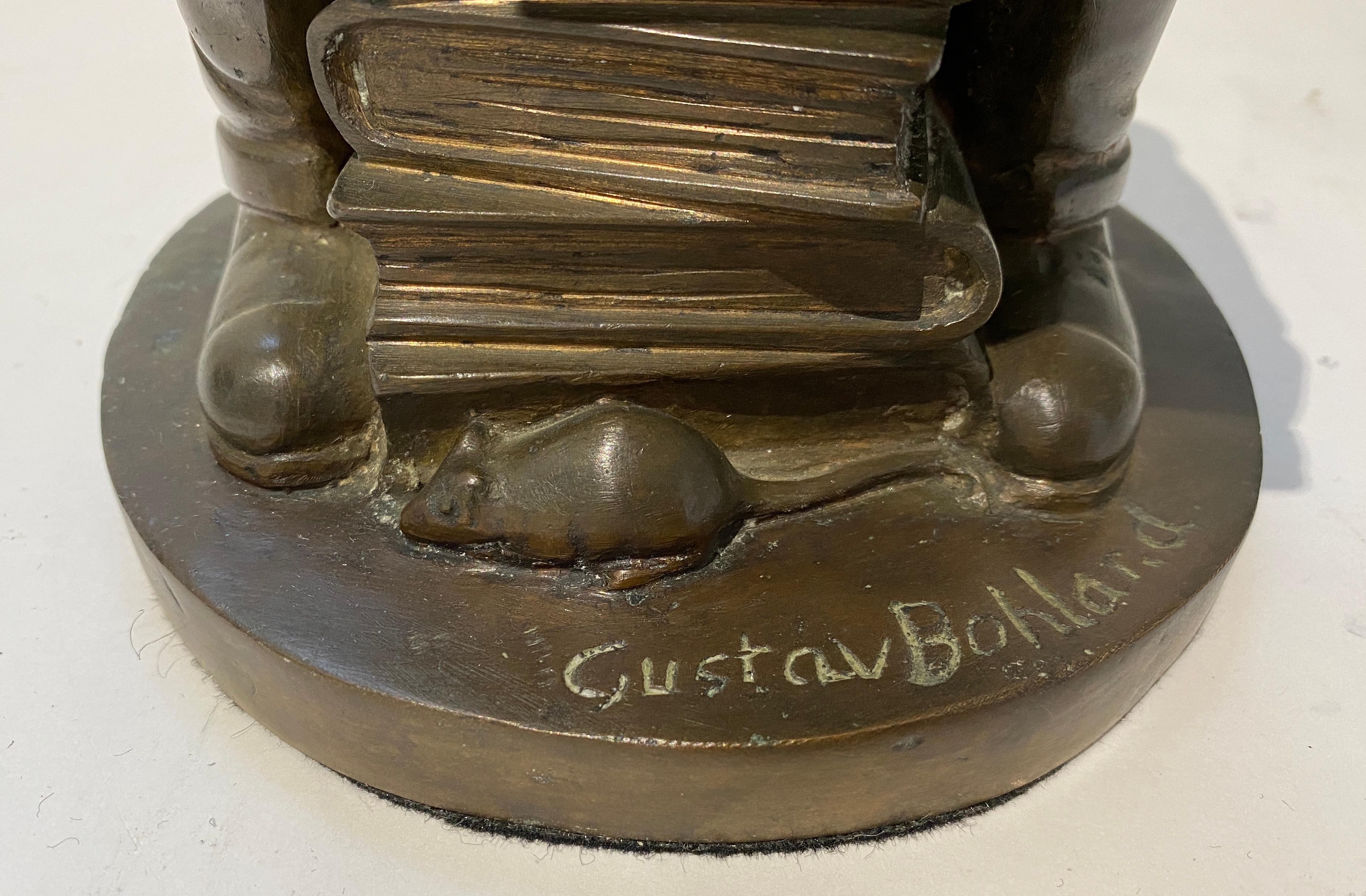 This humorous bronze captures a gentleman surrounded by his books, and he seems to be lost in thought as his cat contemplates his next meal.

Note: Signed on the base Gustav Bohlard (b1897 d1959) who was born in Austria and imigrated to the U.S.