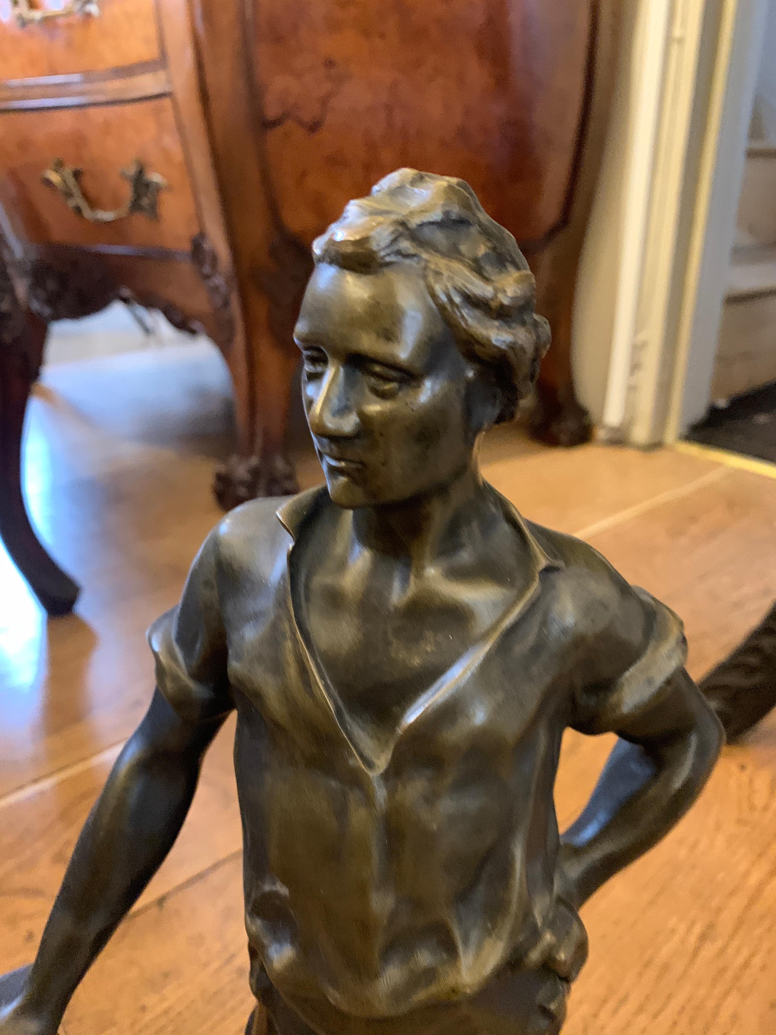 Bronze sculpture of a working man holding a sledgehammer
circa 1880-1900.