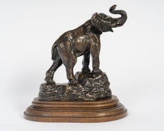 Bronze Sculpture of an Elephant, Trunk Raised, in Patinated Bronze, E. Bernard.