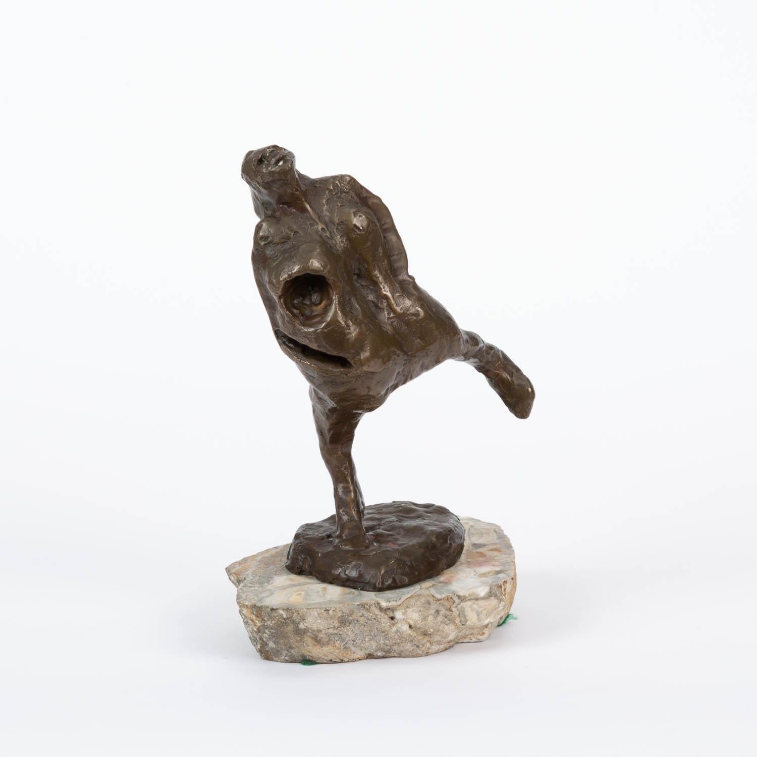 Cast bronze sculpture of dancing woman mounted on stone. Stamped 