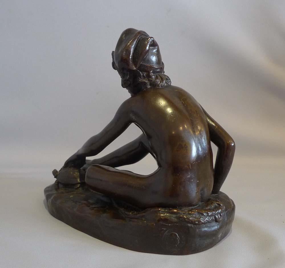 Fine antique cast of the famous sculpture of the Neopolitan fisher boy by Francois Rude. The young boy is sitting on a fishing net and holds on to a turtle. Deep brown patination. It has the Collas Reduction Mechanique and is the 16 cm or smallest