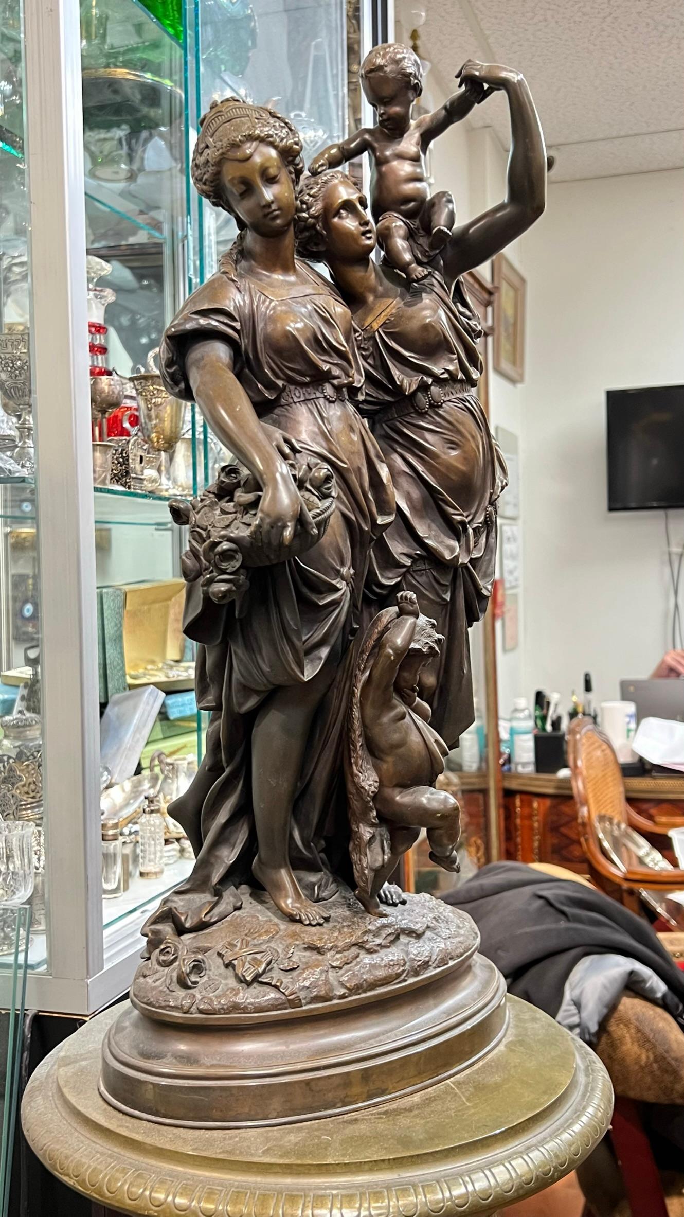 Our wonderful patinated bronze figure of three neoclassical females and a joyful child is signed Carrier for Auguste Joseph Carrier (French, 1800–1875).