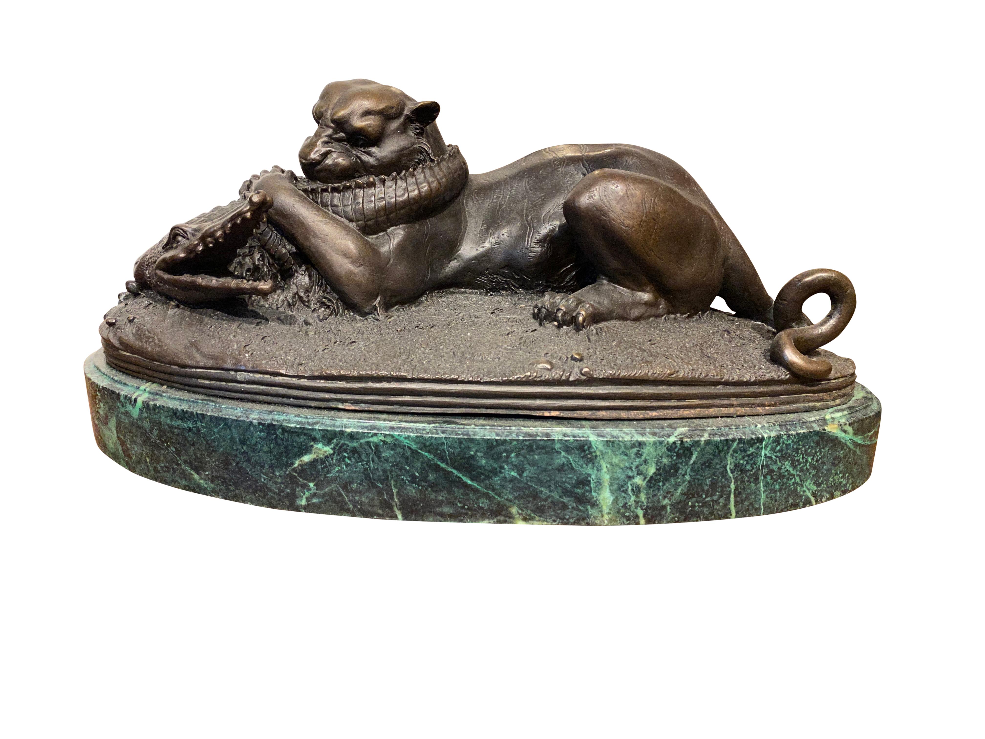 A stunning bronze sculpture of panther and crocodile fight, 20th century. The Spectacular scene depicts a panther and a crocodile in battle. It has a beautiful dark brown patina, and sits on an oval of verde marble. Wonderful details! The cat's