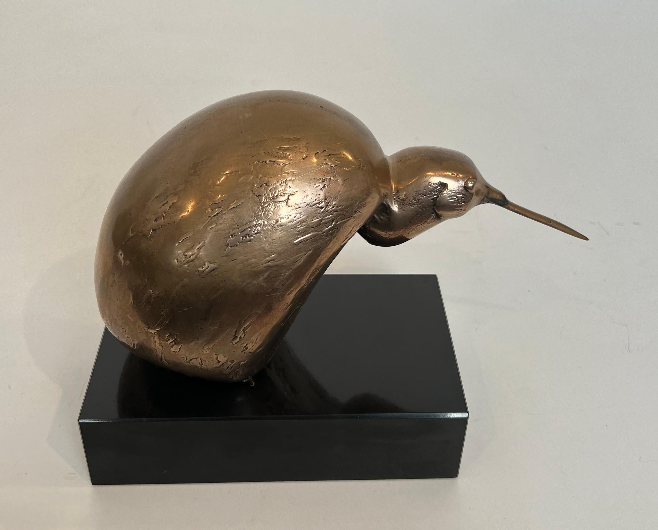This nice and unusual sculpture representing a stylized bird is made of bronze on a black marble base. This is a Belgian work Signed and Numbered 302/500