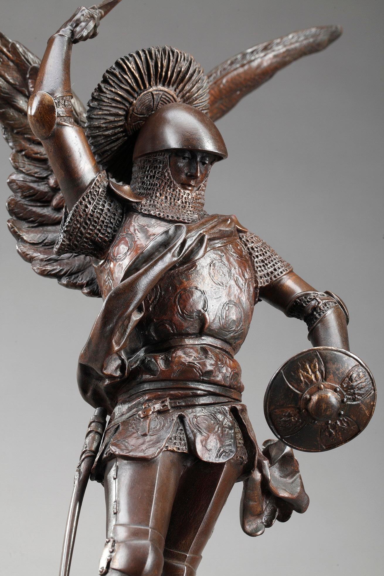 Bronze sculpture with brown patina featuring Saint-Michel terrassant le dragon [St Michael Slaying the Dragon] by Emmanuel Fremiet (French, 1824-1910). In 1894, Emmanuel Fremiet was chosen to design the statue to crown the abbey of Mont Saint