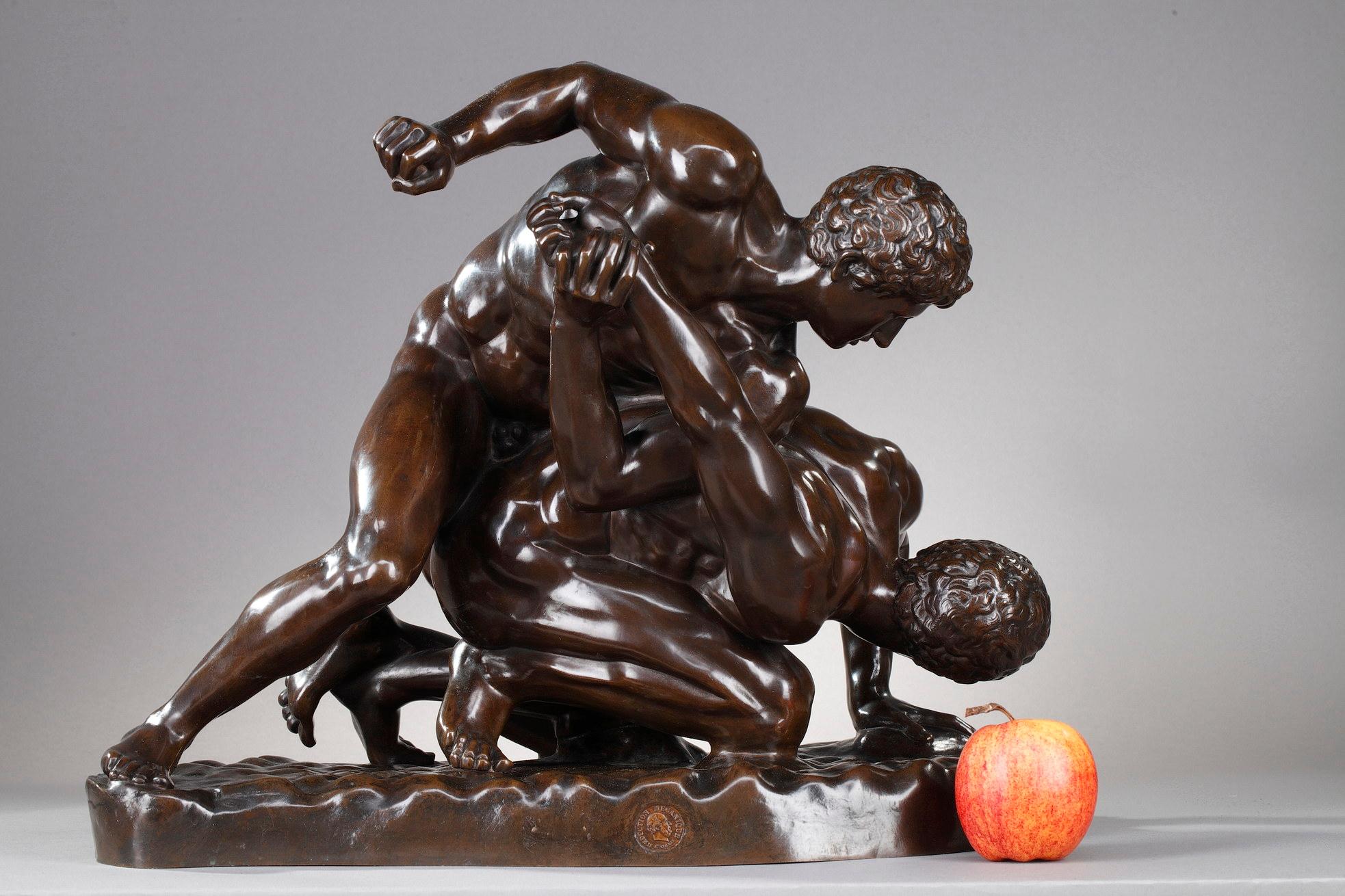 Patinated bronze sculpture after Philippe Magnier (1648-1715) made by the Barbedienne foundry using the Collas mechanical reproduction process. This sculpture represents two nude men on the ground wrestling. They rest on a oval base. The bronze is