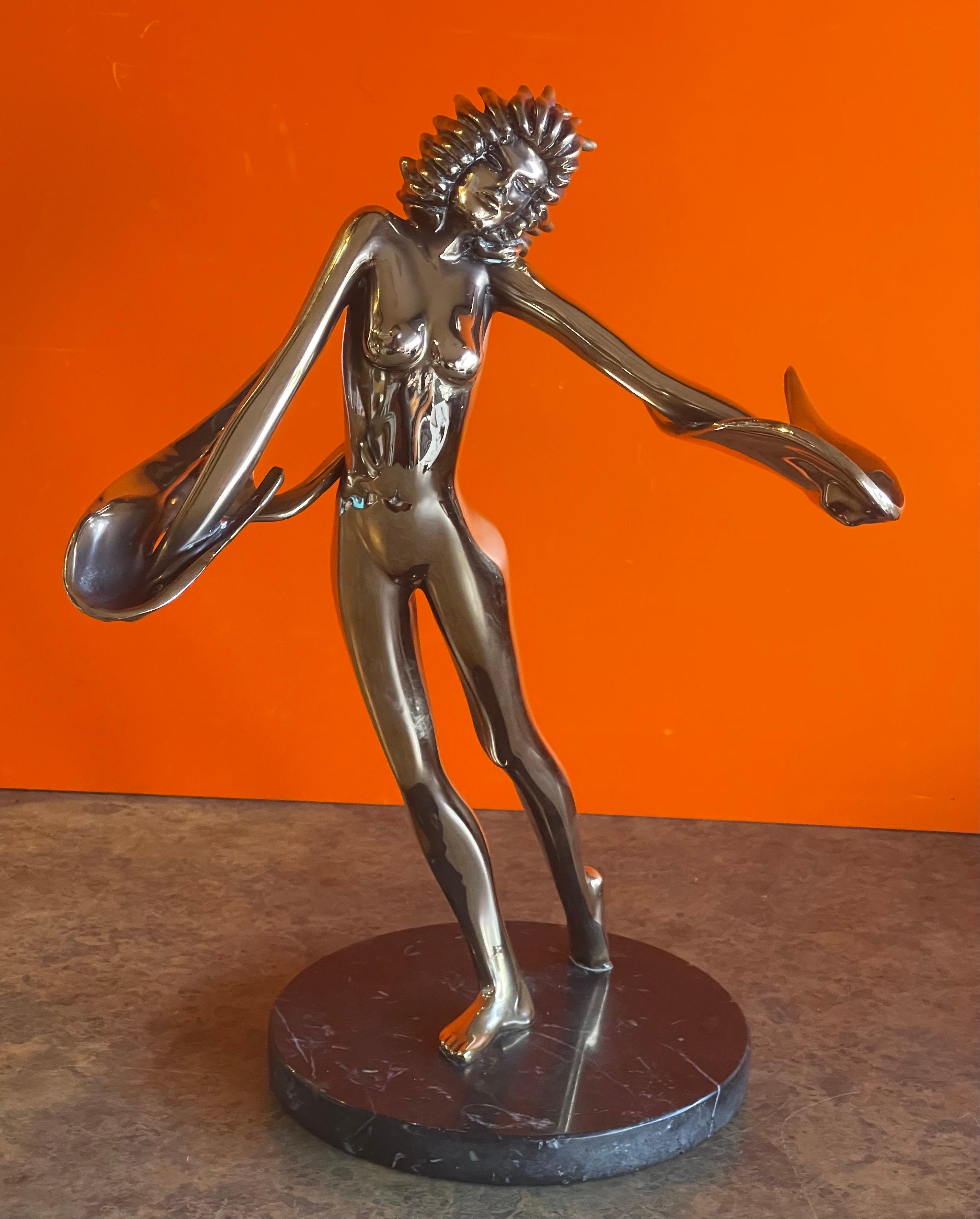 Stylized nude bronze sculpture on black marble base entitled 