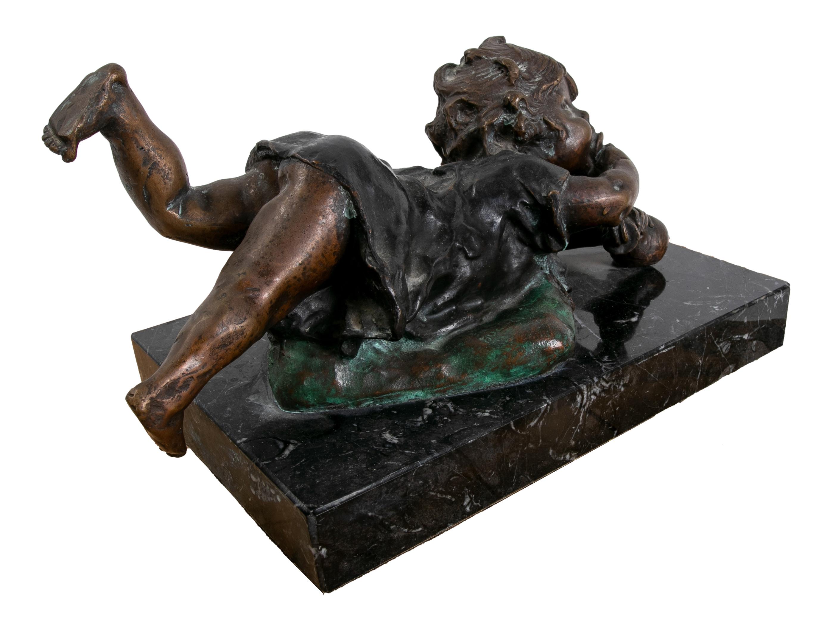 Spanish Bronze Sculpture with Marble Base of a Little Girl Lying Down. For Sale