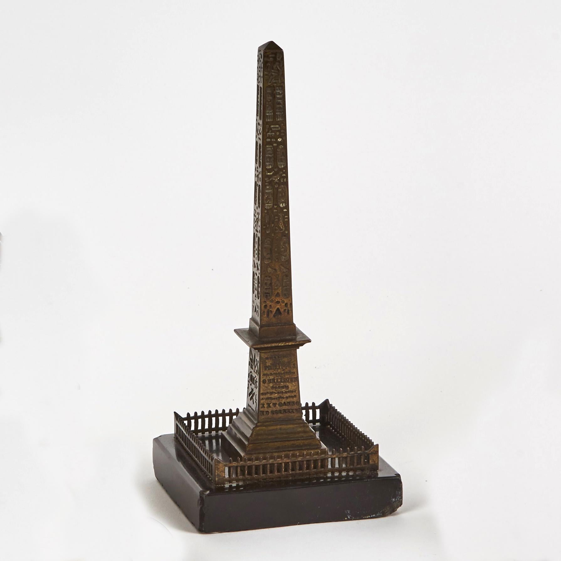 Collection of 19th-century French bronze sculptures of landmark monuments. Each piece is mounted on a smooth black marble base. The ancient Egyptian Luxor Obelisk, Paris's Arc de Triomphe and the Place Vendôme's famous column comprise this