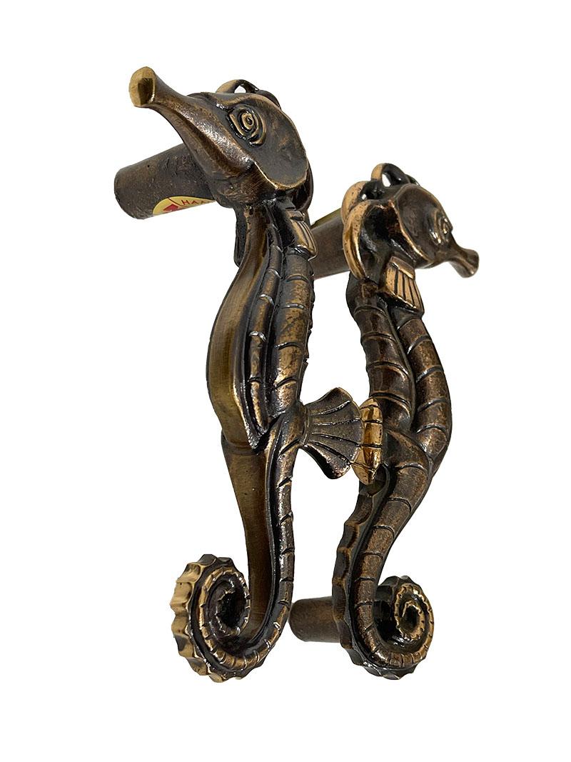 Bronze Seahorse push and pull door handles, 1970s

Solid bronze door handles by MEKO, Germany 1970s. 
Two mirrored door handles with a scene of a Seahorse. Labeled with the brand MEKO Modell, Handarbeit (hand made) , Bronze. 
The measurement is 17