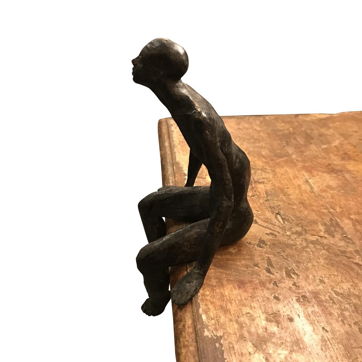 Contemporary German handcrafted seated bronze male figure sculpture.