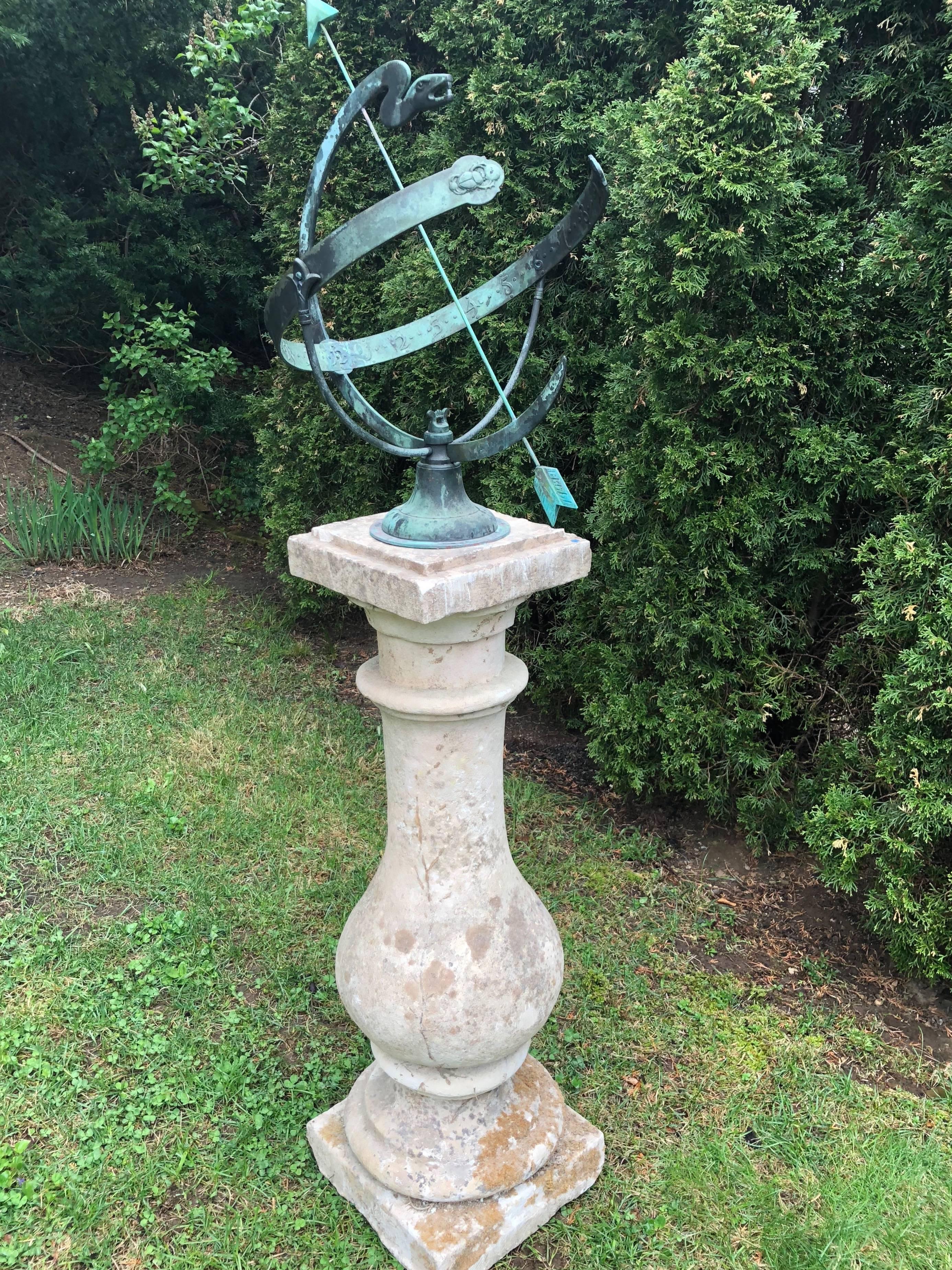 The rare form of this bronze serpent armillary, its large size and gorgeous natural verdigris patina make it a most desirable piece. The armillary features a fanged serpent, stunning bas relief hour numbers, and two beetle scarabs at the ends of the
