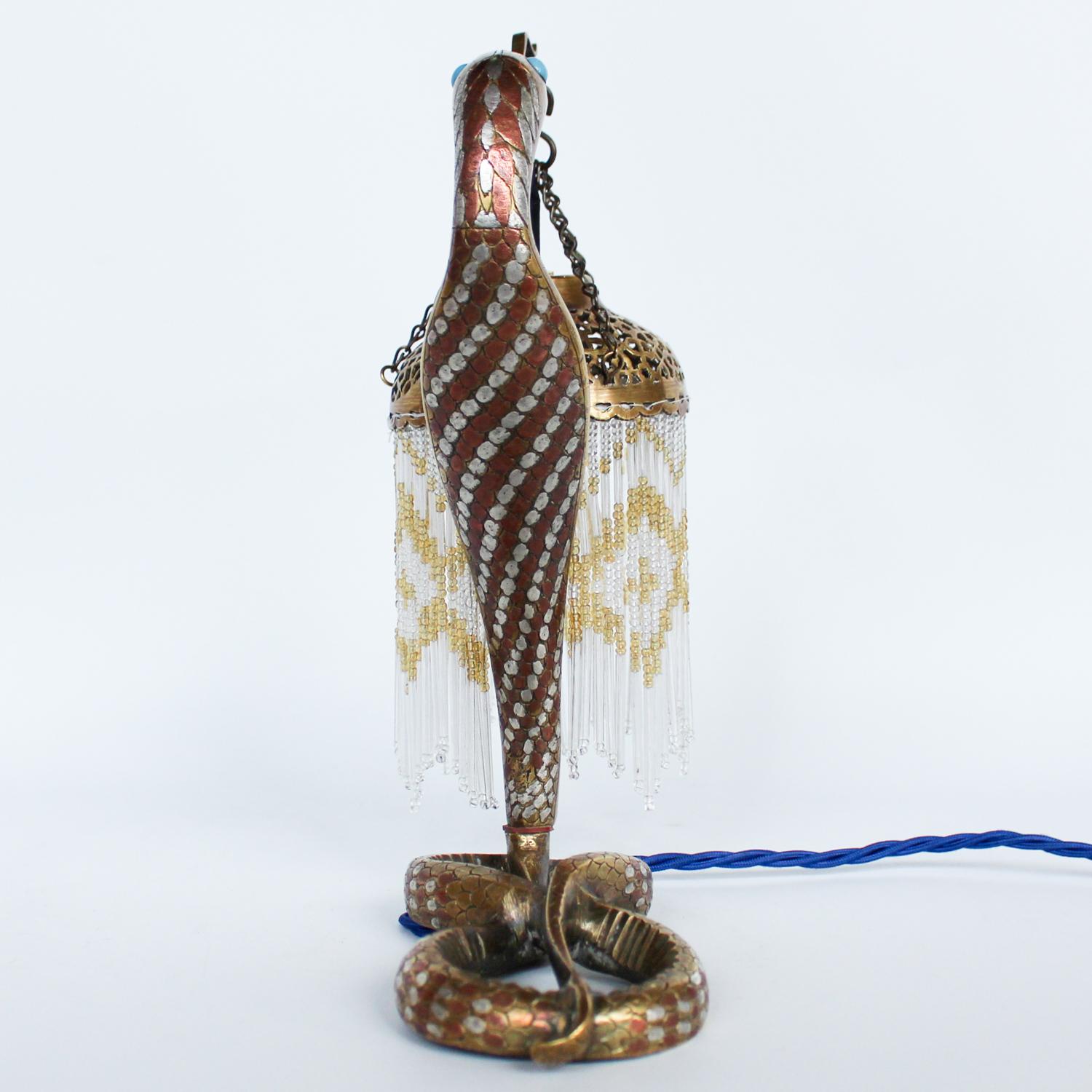 A cold painted bronze serpent lamp, with beaded shade. Signed 'VV' to neck and 'VO' to base. 







  