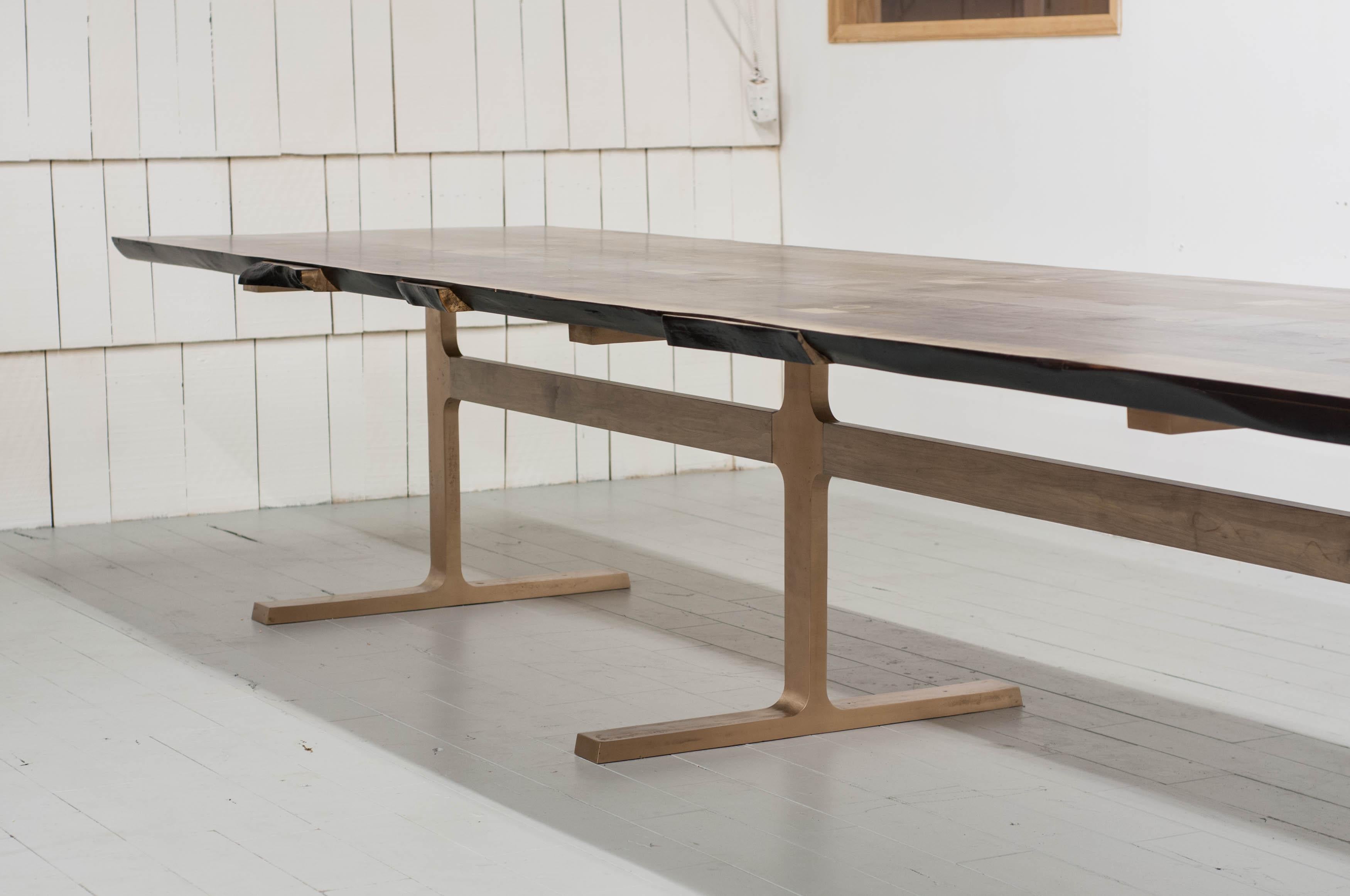 Award winning design from the Vancouver based studio Jeff Martin Joinery.

Distilled to its purest elements, the bronze Shaker table utilizes cast joinery components in the bronze legs and inlayed bronze rings in the wood top.

Available