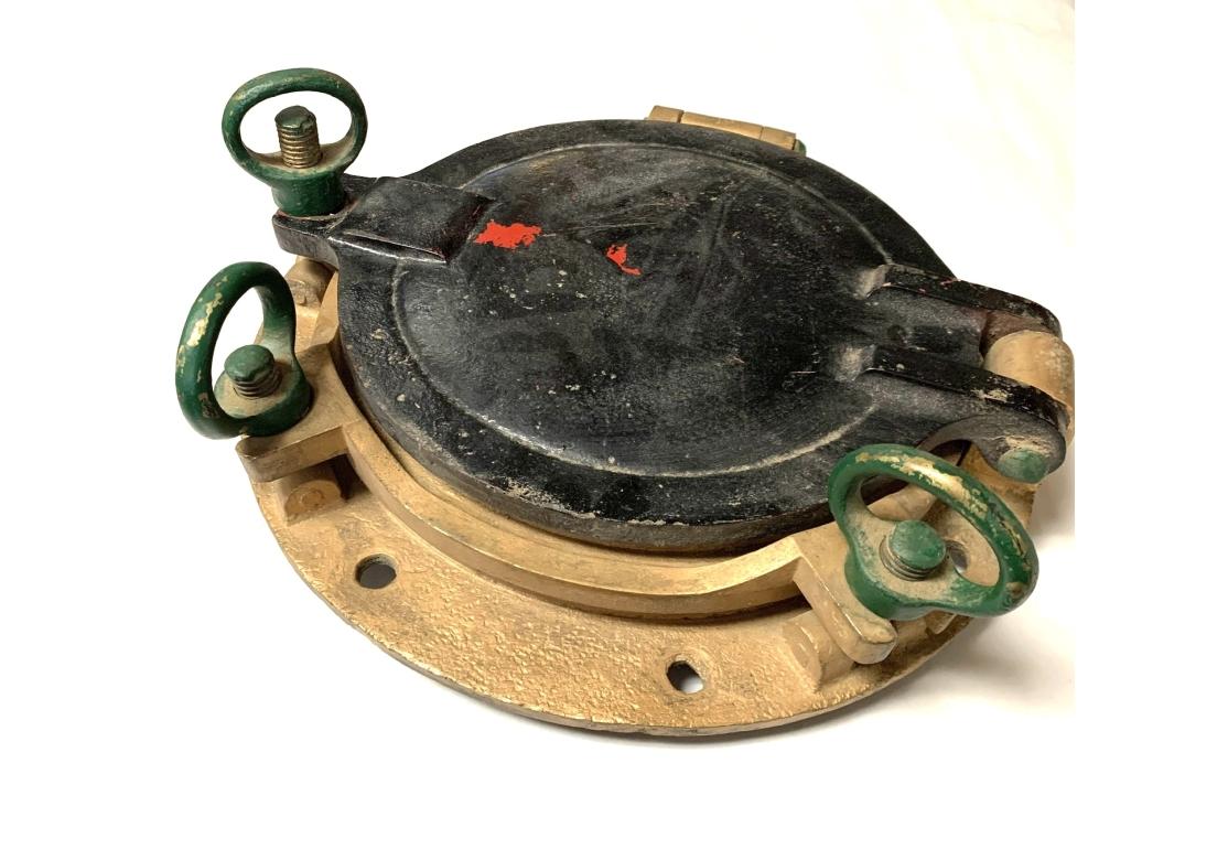 Vintage heavy paint decorated bronze porthole with dog ear locks and glass. Stamped indistinctly on verso and on lock as shown.

Dimensions: 14 3.4