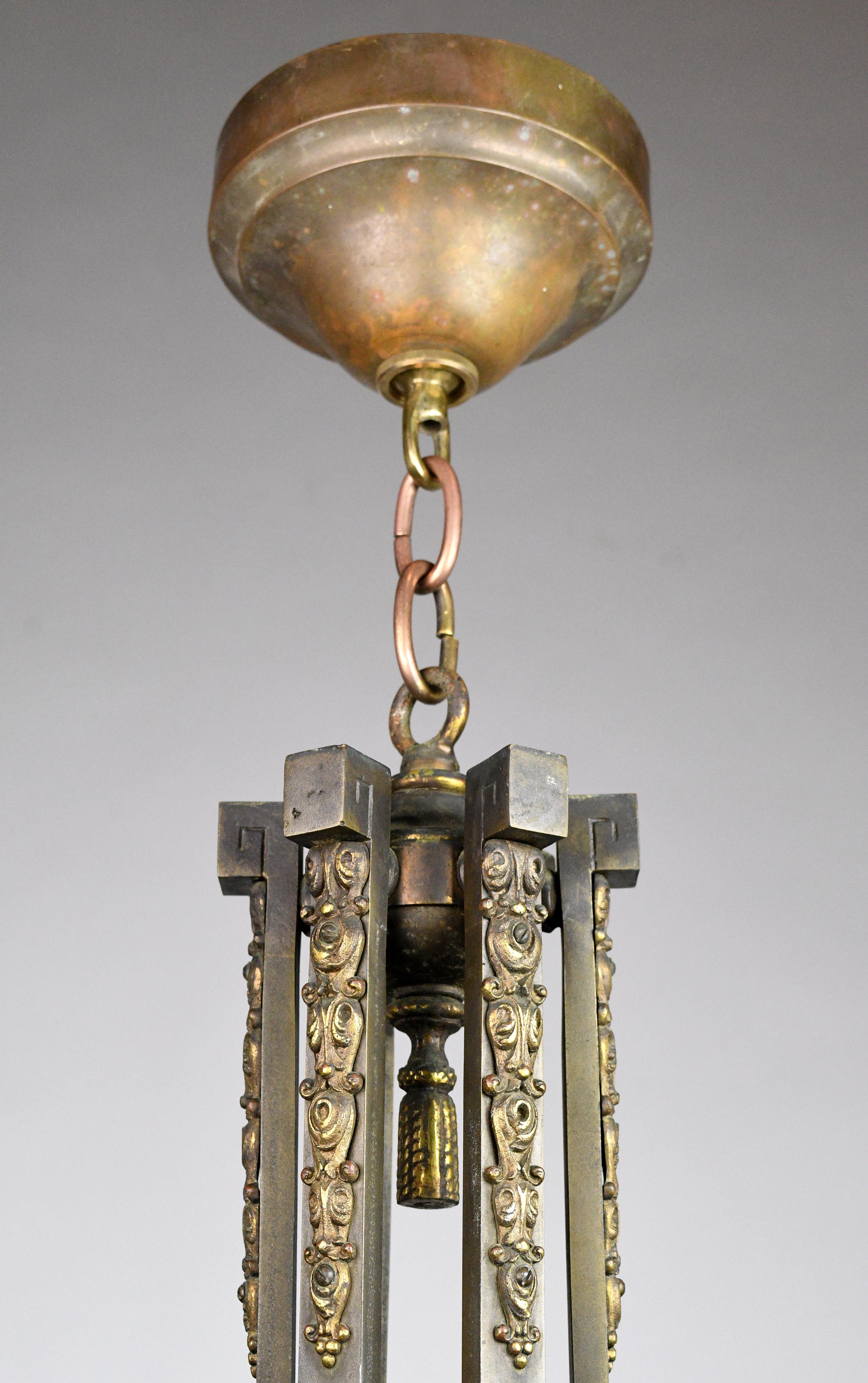 Elegant bronze chandelier with gracefully curving lines and swirling details throughout. Six “arms” swoop downward at an extreme angle, lending a dynamic quality to the fixture. At the bottom, a pronounced finial adds to the robust quality.

circa